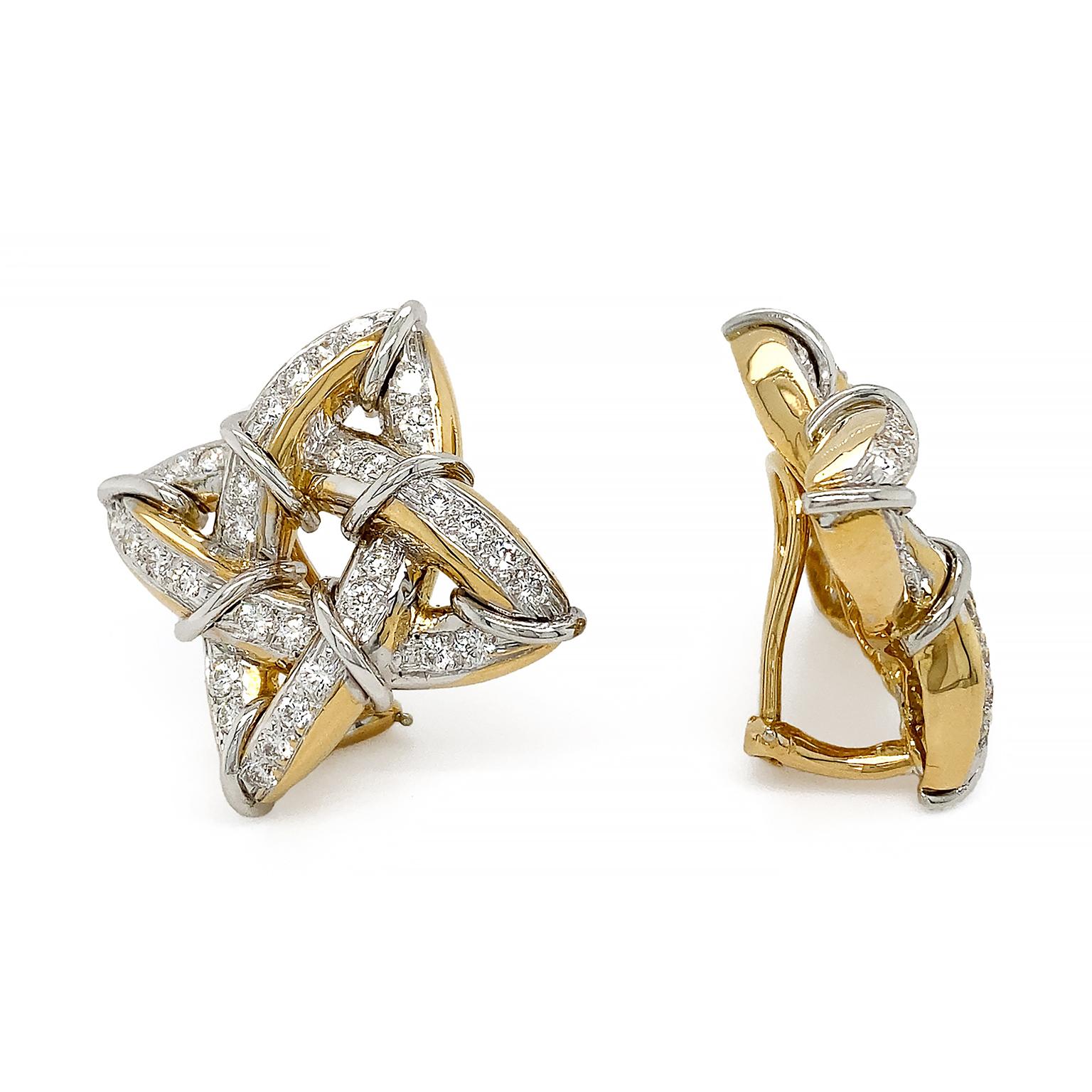 The timeless gothic motif is the inspiration for these earrings. A triangular accented knot of 18k yellow gold features a row of brilliant cut diamonds set in platinum across the top. Platinum wires wrap around the sides, while the sheen of gold is
