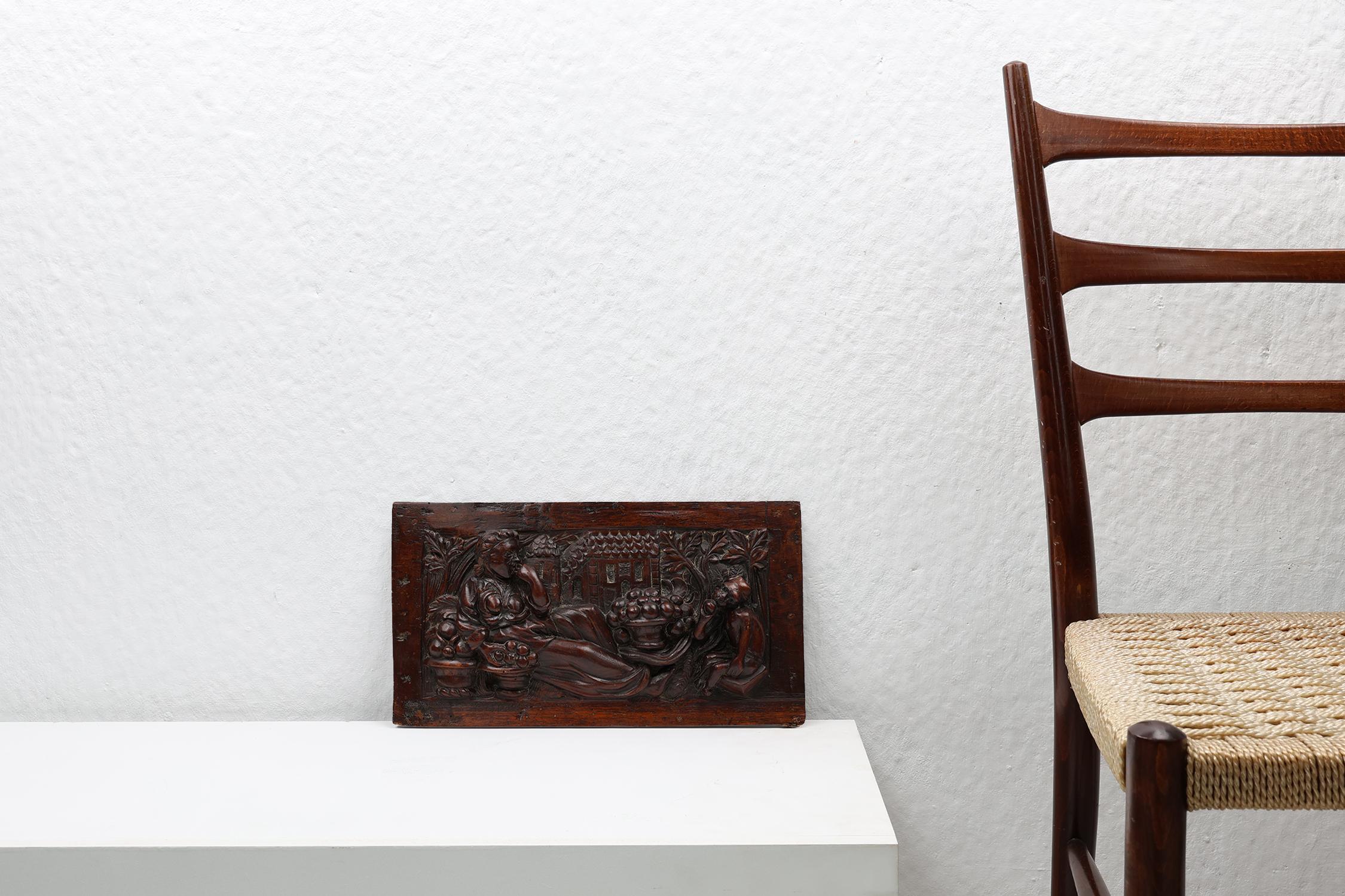 Belgium / 17th century / wooden sculpted panel / oak / Gothic / Rustic / Antique

A panel in oak wood enriched with Gothic carvings. Hand carved in Belgium in the 17th century. This antique artwork shows a woman and a boy eating fruit from baskets