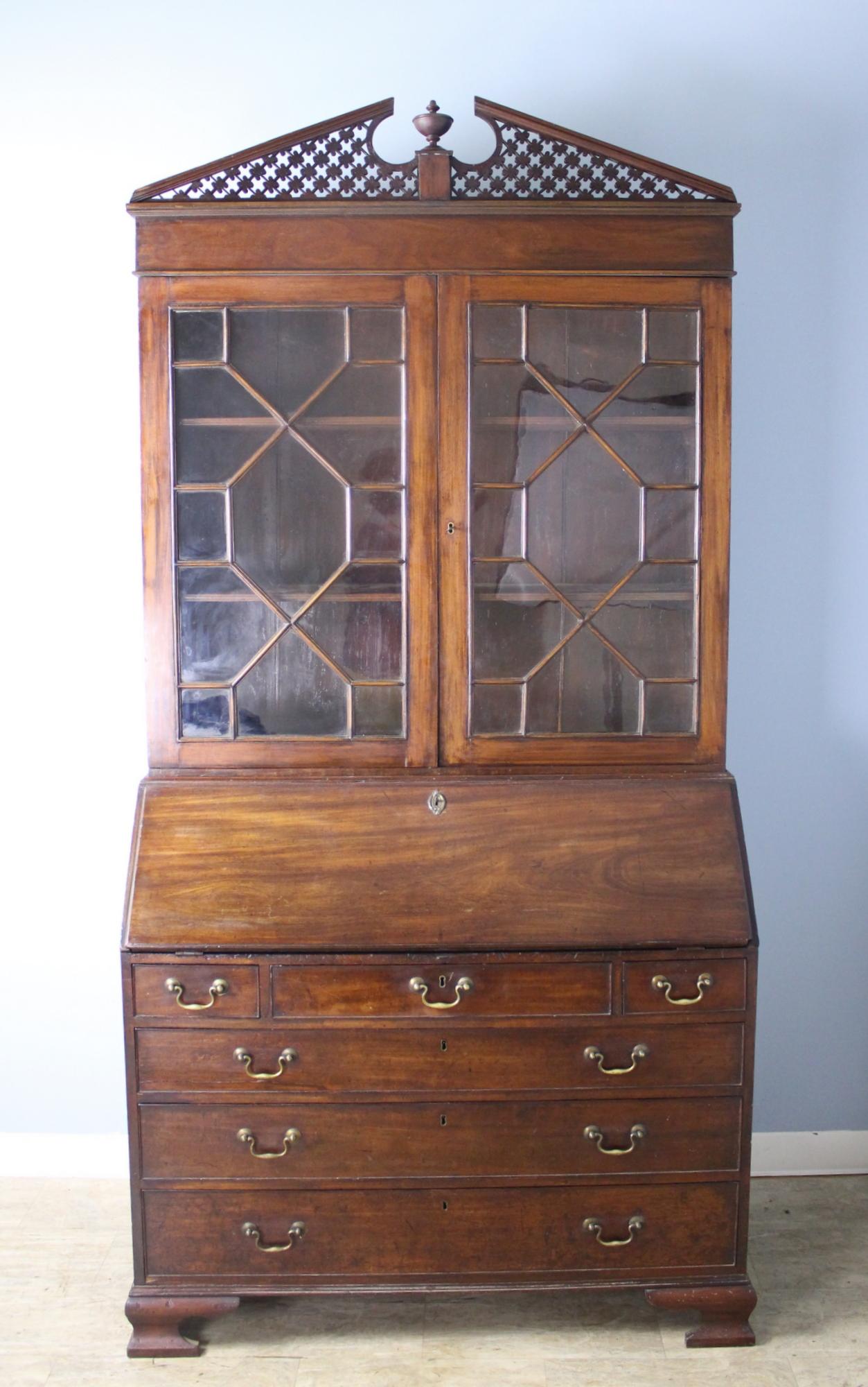 A fine example of multipurpose 18th century Gothic English furniture, with a generously proportioned bookcase on top, and built in secretaire or bureau with a flip down writing surface and charming cubbies and small drawers. Classic three over three