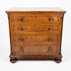 Gothic oak chest of drawers decorated with carved masks and columns