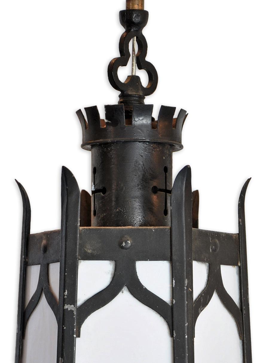 Condition: Very good
Finish: Original
Material: Iron
Country of origin: USA
Illumination: 1 medium base bulbs,
circa 1930s

Measures: 29.25” height, 11” diameter

These hexagonal Gothic pendant pair are dominated by the strong vertical