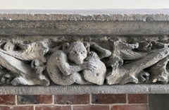 Gothic period stone mantelpiece with monsters and carved capitals