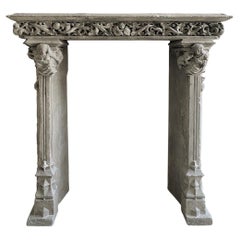 Gothic period stone mantelpiece with monsters and carved capitals