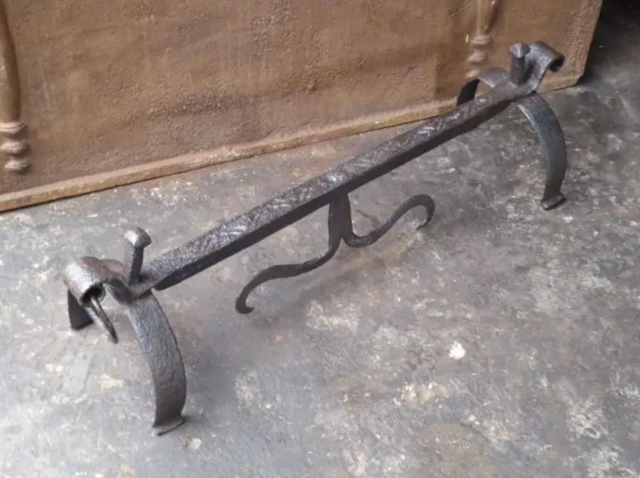 Unique hand forged rest to place fireplace tools near the fireplace.