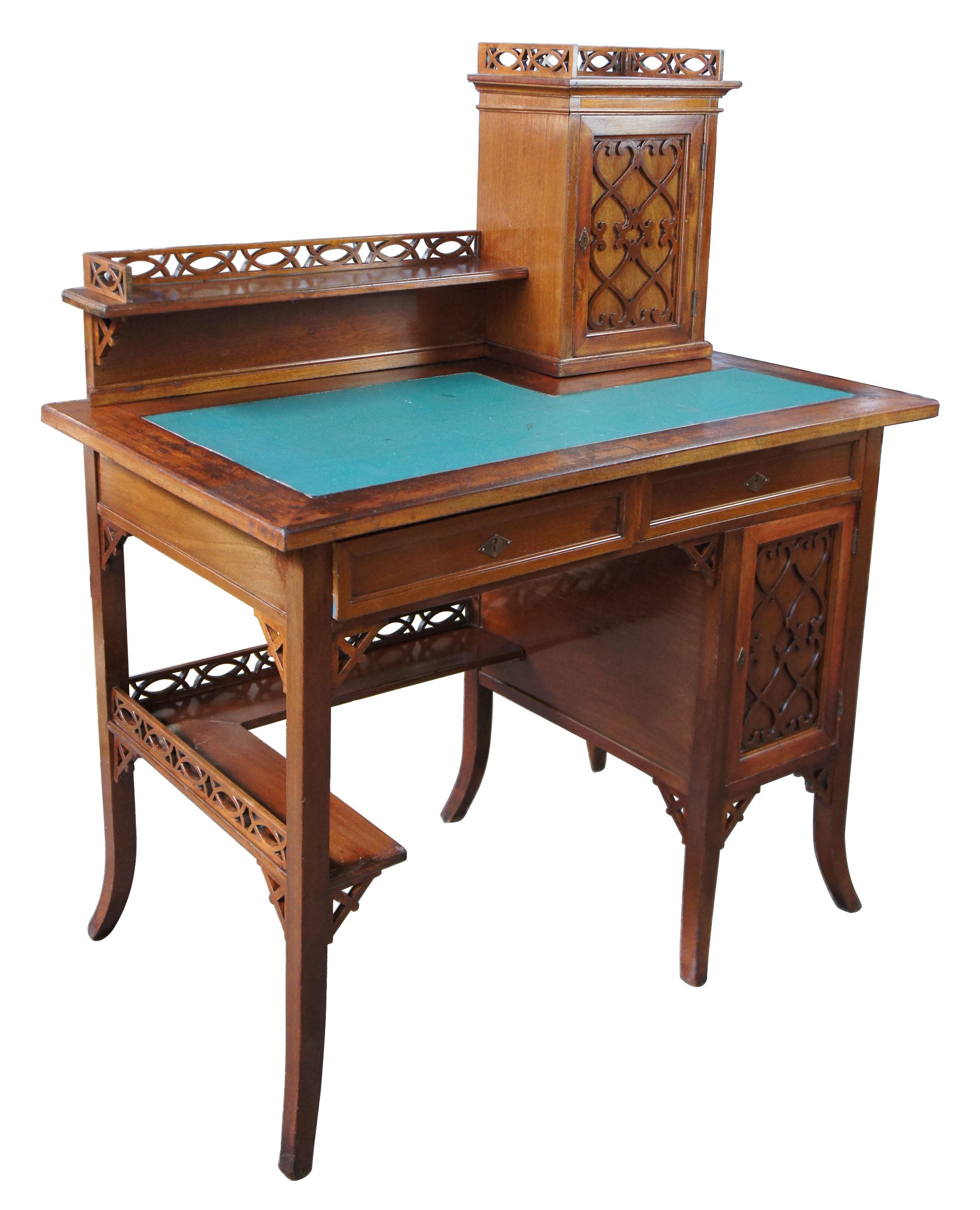 Gothic Revival antique German writing desk green vinyl top pierced fretwork

Late 19th century Gothic Revival writing desk. Made from walnut with vinyl inset top and back-splash. This stunning desk is covered in fretwork from the lower and upper