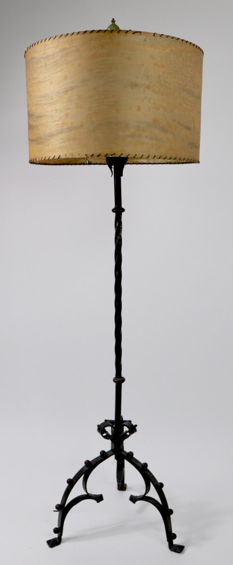 Very well executed wrought iron floor lamp in the Gothic style, bears makers initials LO. Original decorative polychrome paint highlighted finish. Clean and working condition, shade not included.