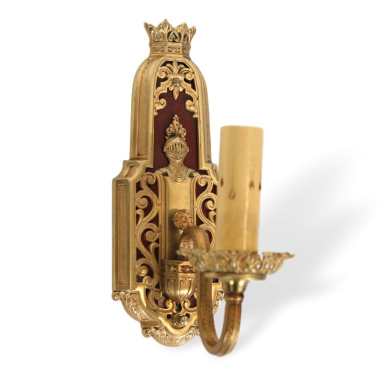 Gothic Revival brass wall sconces, French set of four (4).
Each finely cast with a bust of a figure in medieval armor, with scrolled brass fretwork on an ox blood red ground, topped with a crown.