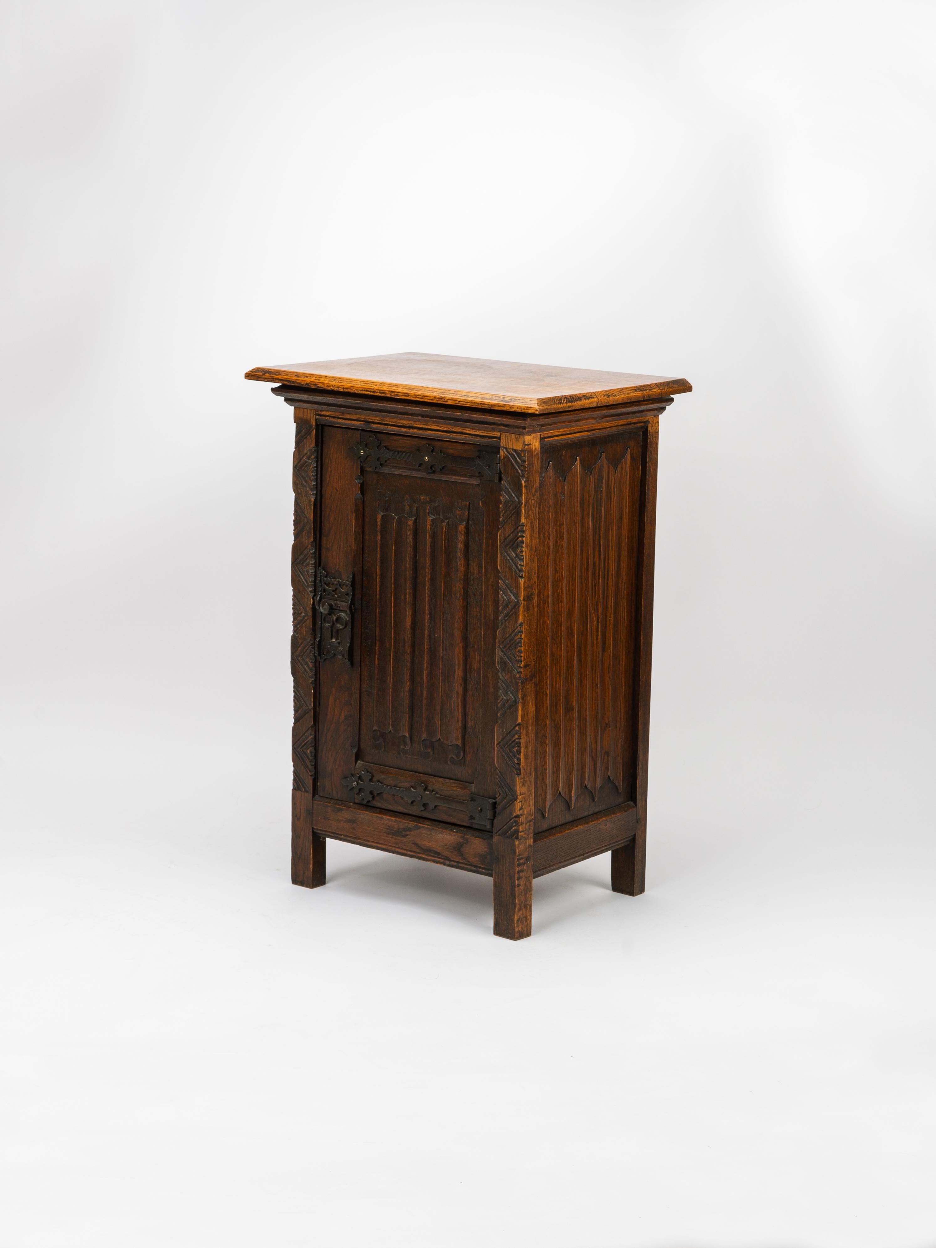 Intricately carved and remarkably crafted, this gothic revival reliquary is a testament to gothic art and architecture. The scrolling motifs carved into the solid oak juxtaposed with the hand forged iron hinges and lock imbue a warm, medieval