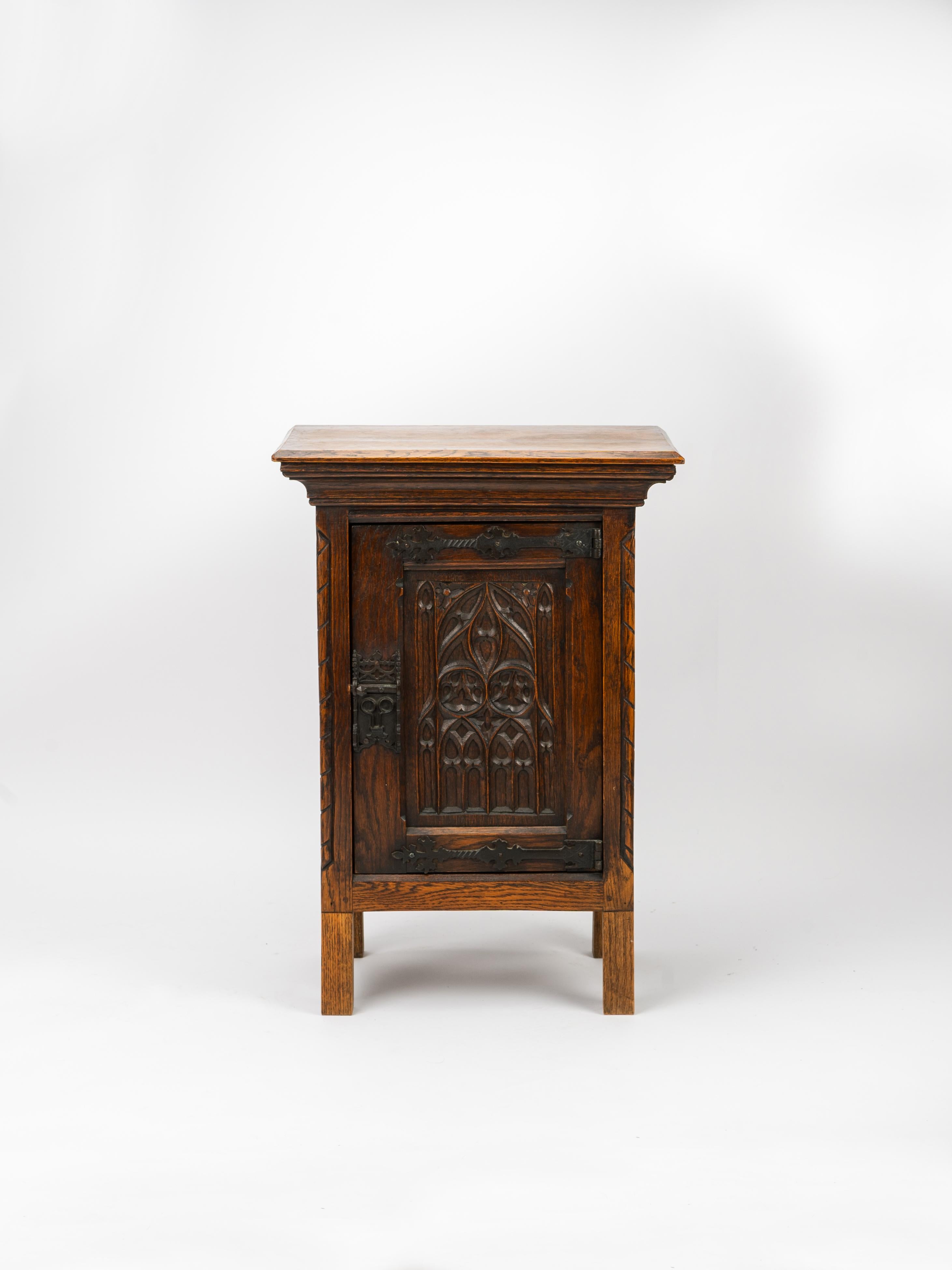 Intricately carved and remarkably crafted, this gothic revival reliquary is a testament to gothic art and architecture. The scrolling motifs carved into the solid oak juxtaposed with the hand forged iron hinges and lock imbue a warm, medieval