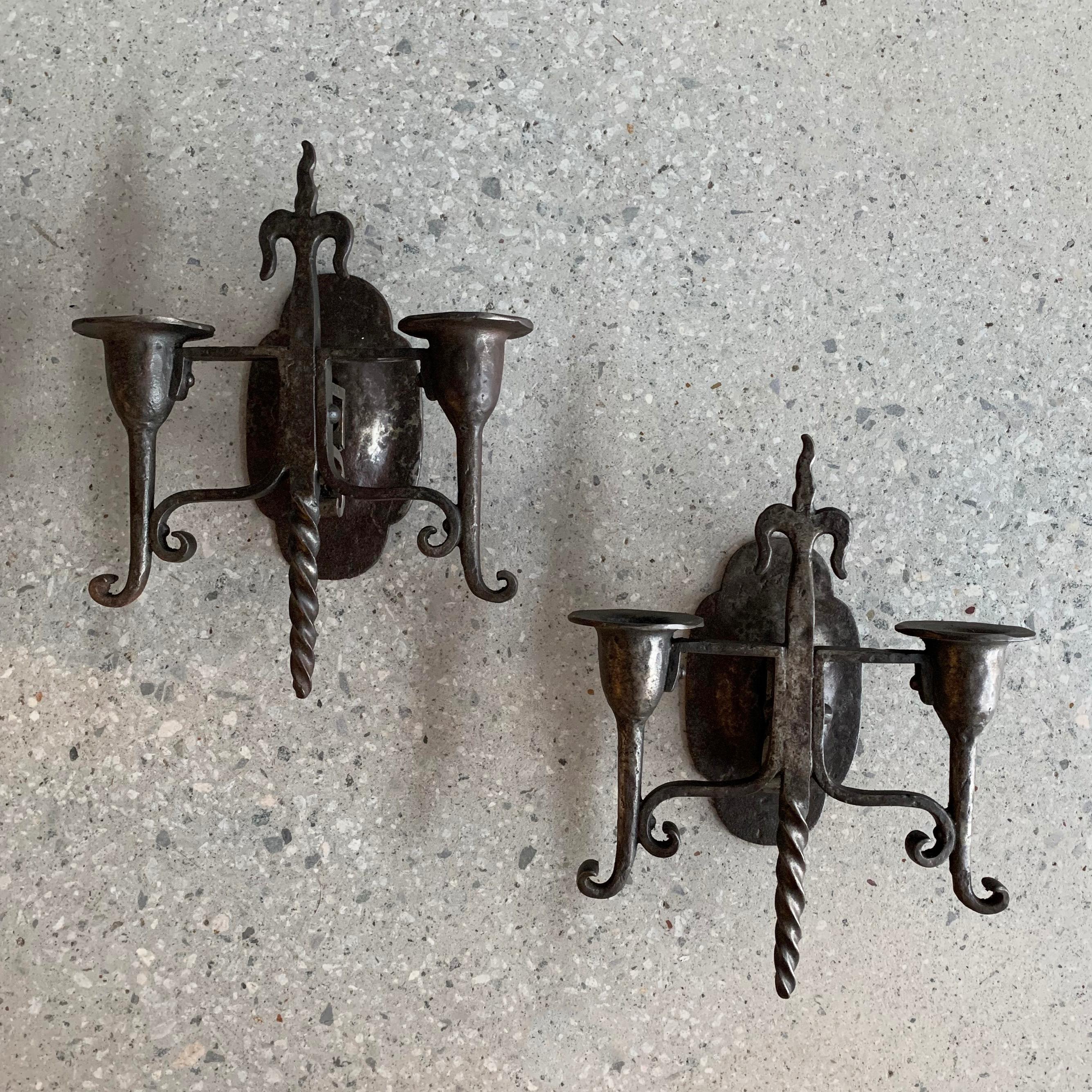 Pair of early 20th century, Gothic revival, cast iron, wall sconces feature two candleholders each.