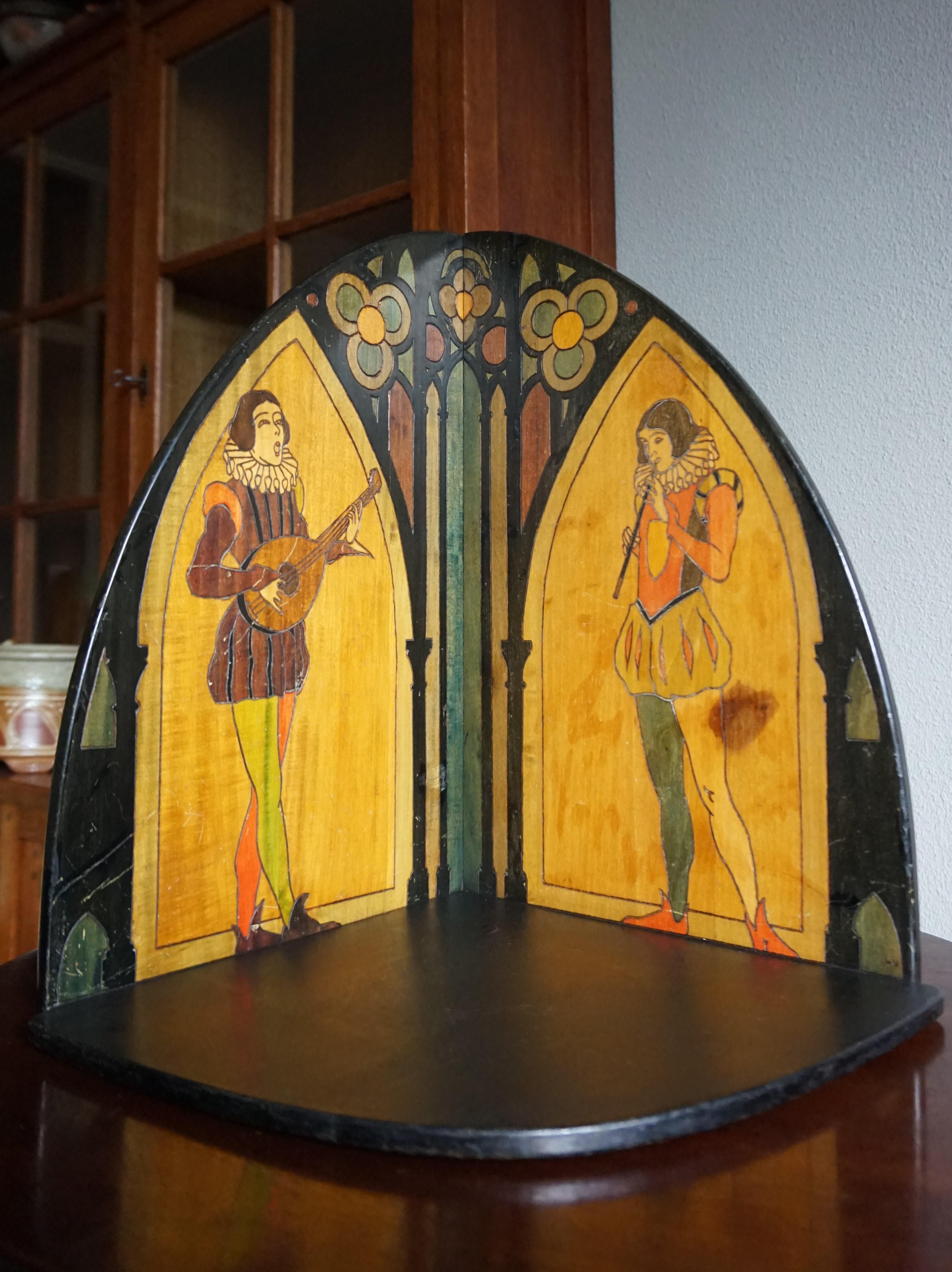 Unique wall bracket with colorful court jesters / musicians.

If you collect one of a kind antiques in the Gothic style then this artistic and all handcrafted corner shelf could be for you. All the outlines of the decorations that you see in this