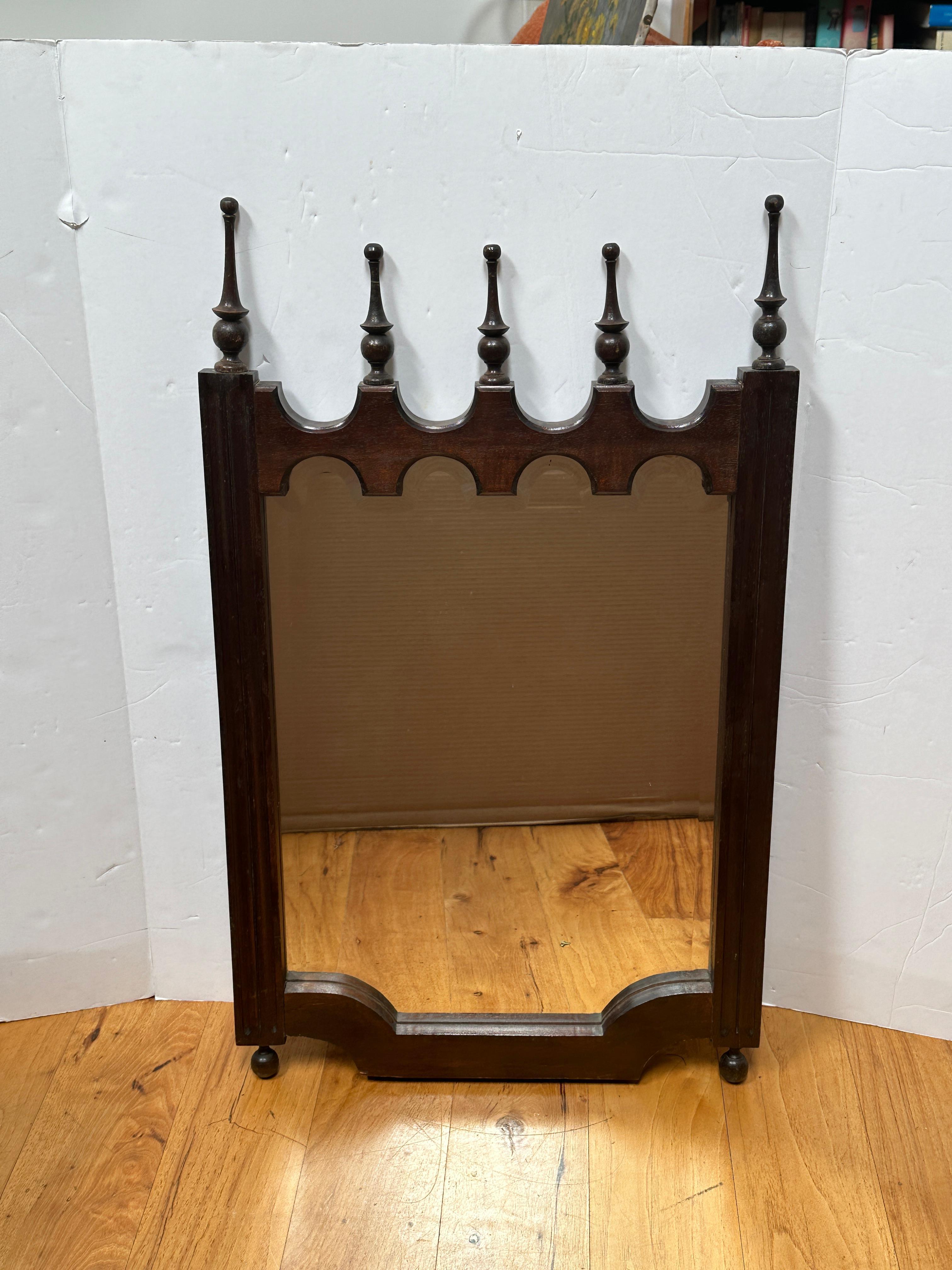This Gothic Revival Ornate Wood Mirror features six intricately carved top branch ornaments, each one meticulously detailed to enhance the mirror's elegant and historic charm.

The top and bottom of the mirror are carved in arches, reflecting the