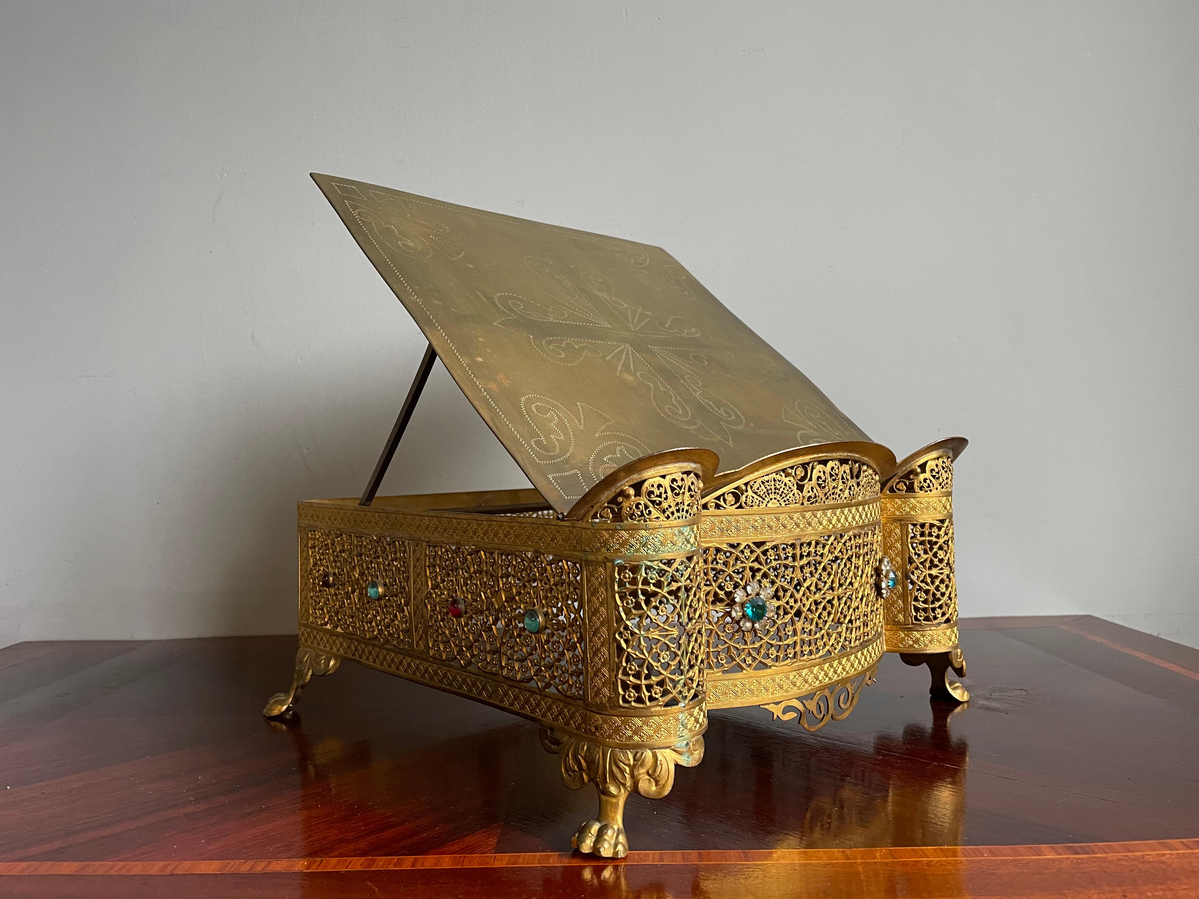 Stunning 19th century Gothic church bible or missal stand with 'gemstones'.

This rare, late 1800s, gilt bronze bible stand has beautiful details and it is in remarkably good condition. The stunning design with the extremely detailed and gilt Gothic