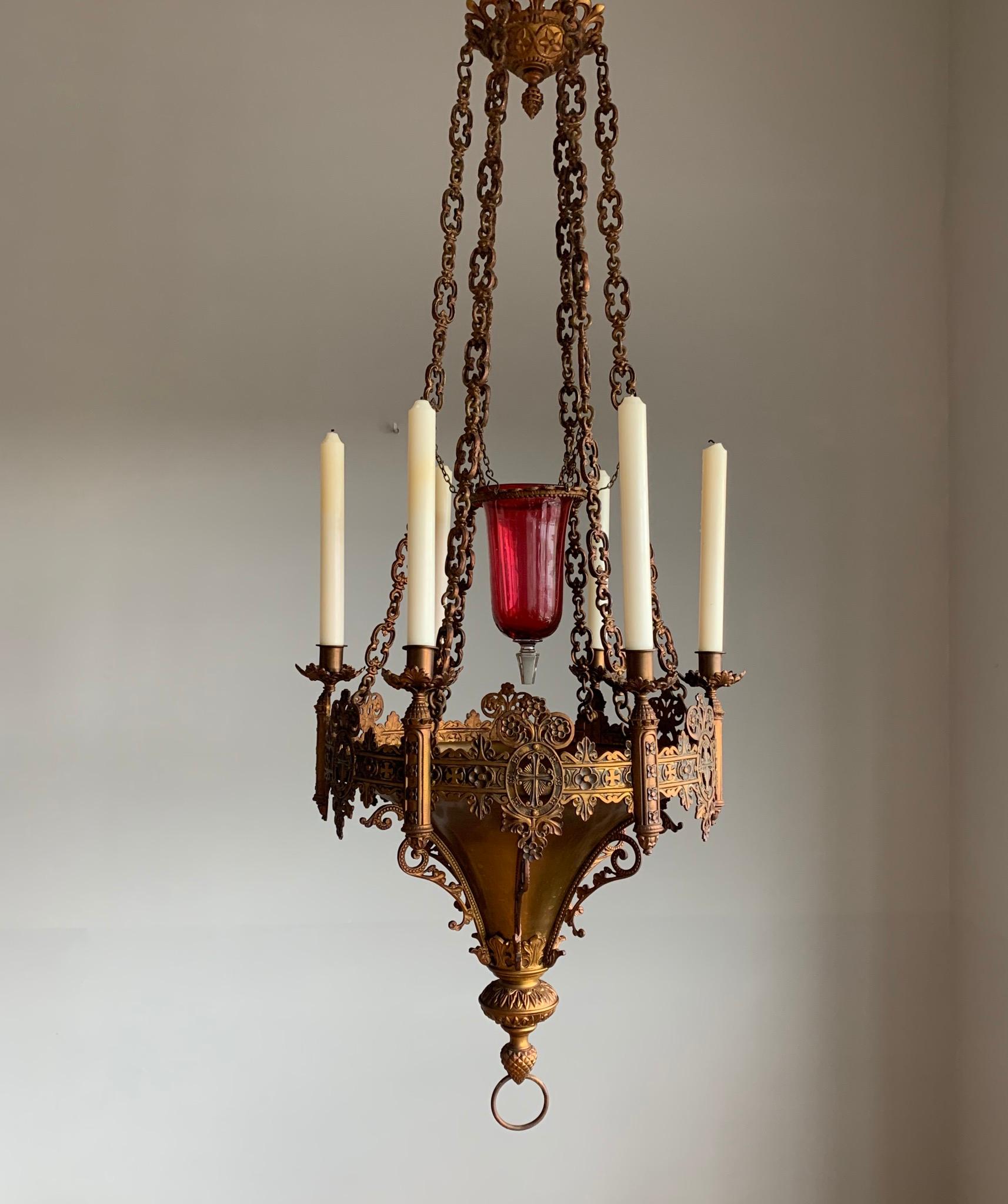 Stunning and all handcrafted church sanctuary light with glass vessel in the center.

If you have a Gothic style interior or if you run a church or monastery then this six candles chandelier will look great wherever you decide to hang it. This