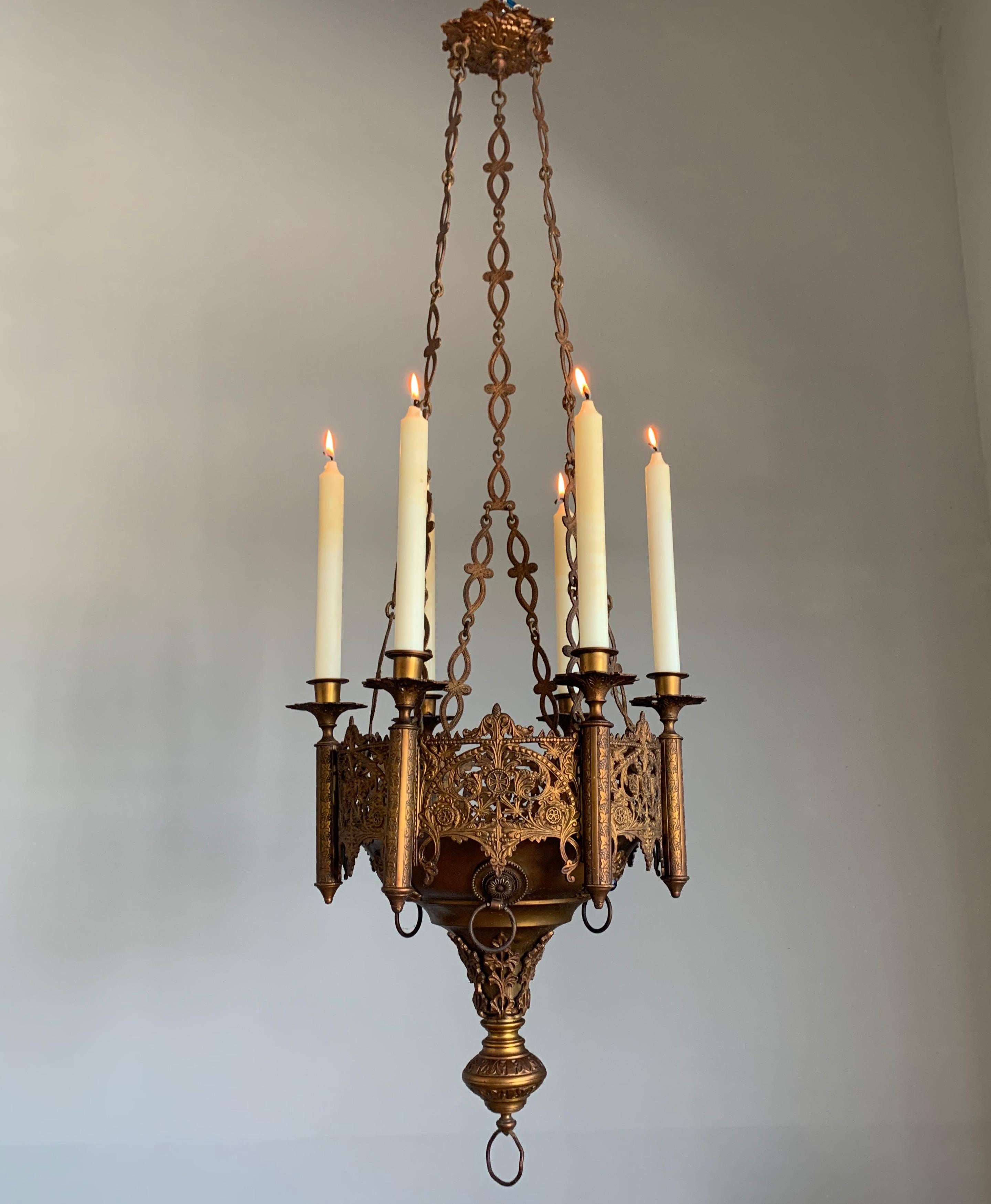 Stunning and all handcrafted church sanctuary light with glass gem stone inserts.

If you have a Gothic style interior then this six candles chandelier will look great wherever you decide to hang it. This particularly fine specimen comes with a wide