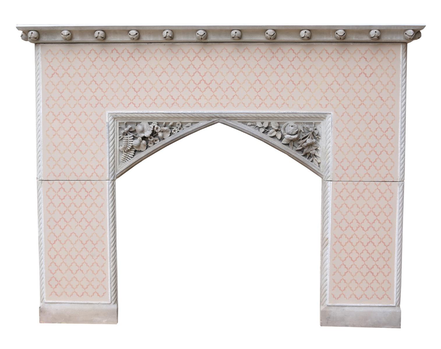 An unusual English Gothic revival fire surround, carved from pale sandstone. The front and the sides of the fire surround have a plaster finish with painted stencil decoration. Salvaged from a property in Cheshire.

Opening Height 81.5 cm (32.09