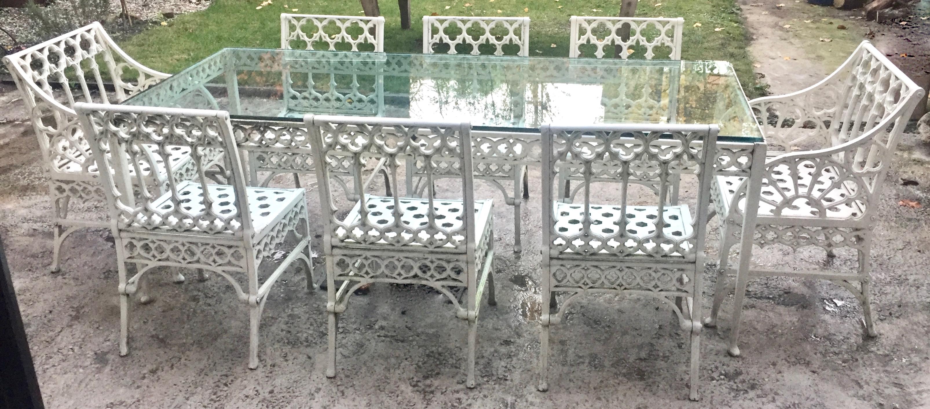 Fantastic cast metal garden set in the gothic revival style circa 1930. Use this set indoors or out.
The set consists of six side chairs, a pair of armchairs and glass top table.
The width of the seats are perfect (17-1/2