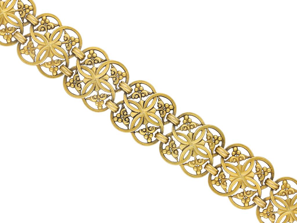 Gothic revival gold bracelet by Wiese. A yellow gold articulated openwork bracelet, flowing with movement, composed of ten quatrefoil shape links each with four textured interlocking hoops with cross motif to the centre, featuring foliage and berry