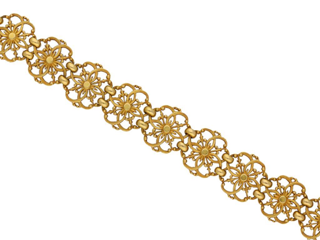 Gothic revival gold openwork bracelet by Wiese. A yellow gold articulated openwork bracelet, flowing with movement, composed of thirteen quatrefoil segments joined by oval links, featuring granulation details, polished borders and fancy pierced