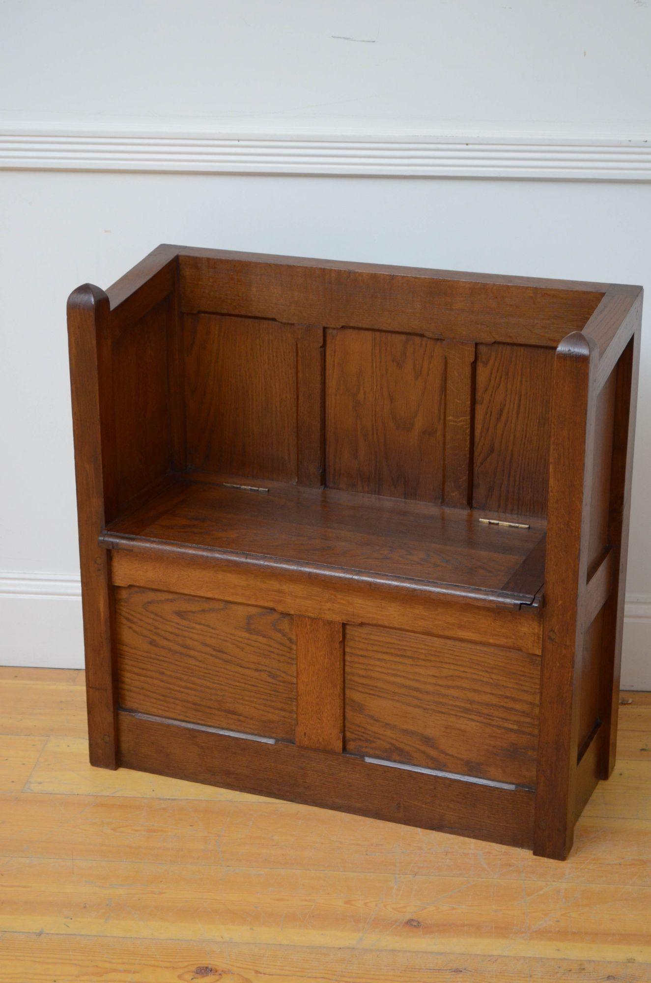 St016 Victorian Gothic Revival hall bench in solid oak, having panelled back, sloping sides and lift up seat enclosing storage compartment above panelled base. This antique hall bench retains its original finish, colour and patina, all in home ready