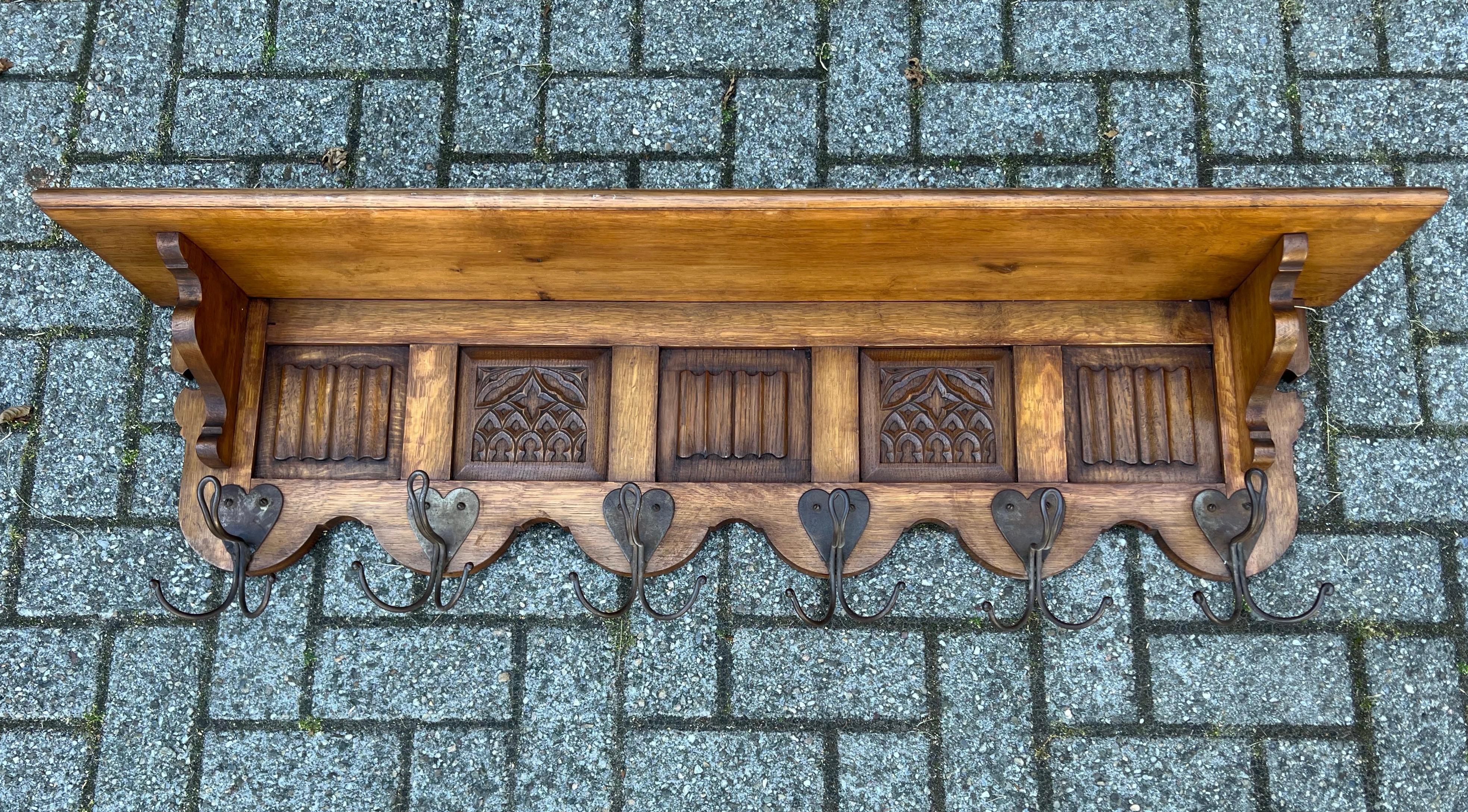 Wonderful craftsmanship, large and solid oak Gothic Revival coat-rack.

Anyone who has ever visited a Gothic (Revival) church or other Gothic style building will immediately recognize the same elements in this hand carved coat rack. The symmetry in