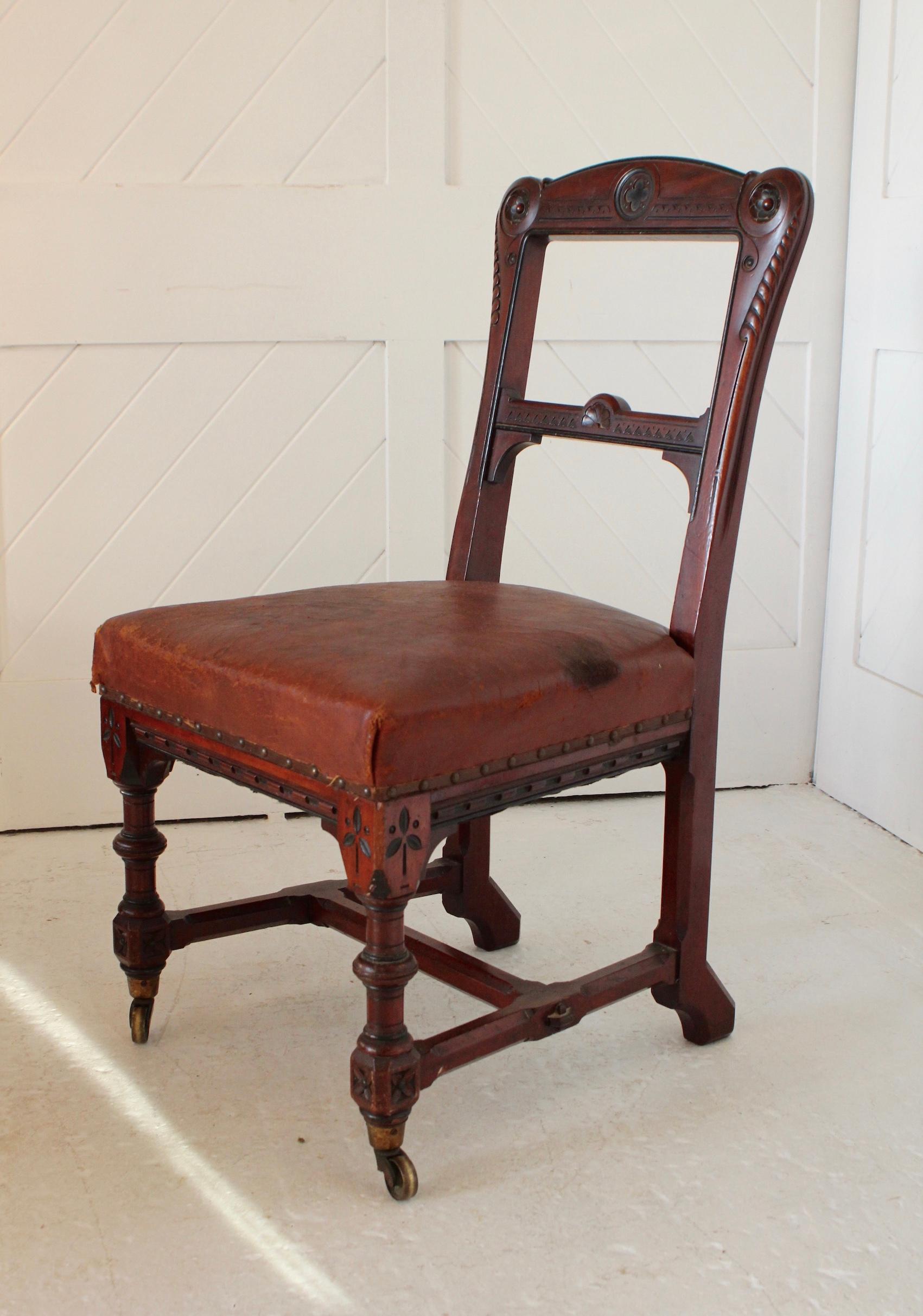 Paire de chaises en acajou de style néo-gothique
Sièges en cuir d'origine
Roulettes en laiton

Design/One et détails en ébène

Circa 1870

Holland & Sons 
