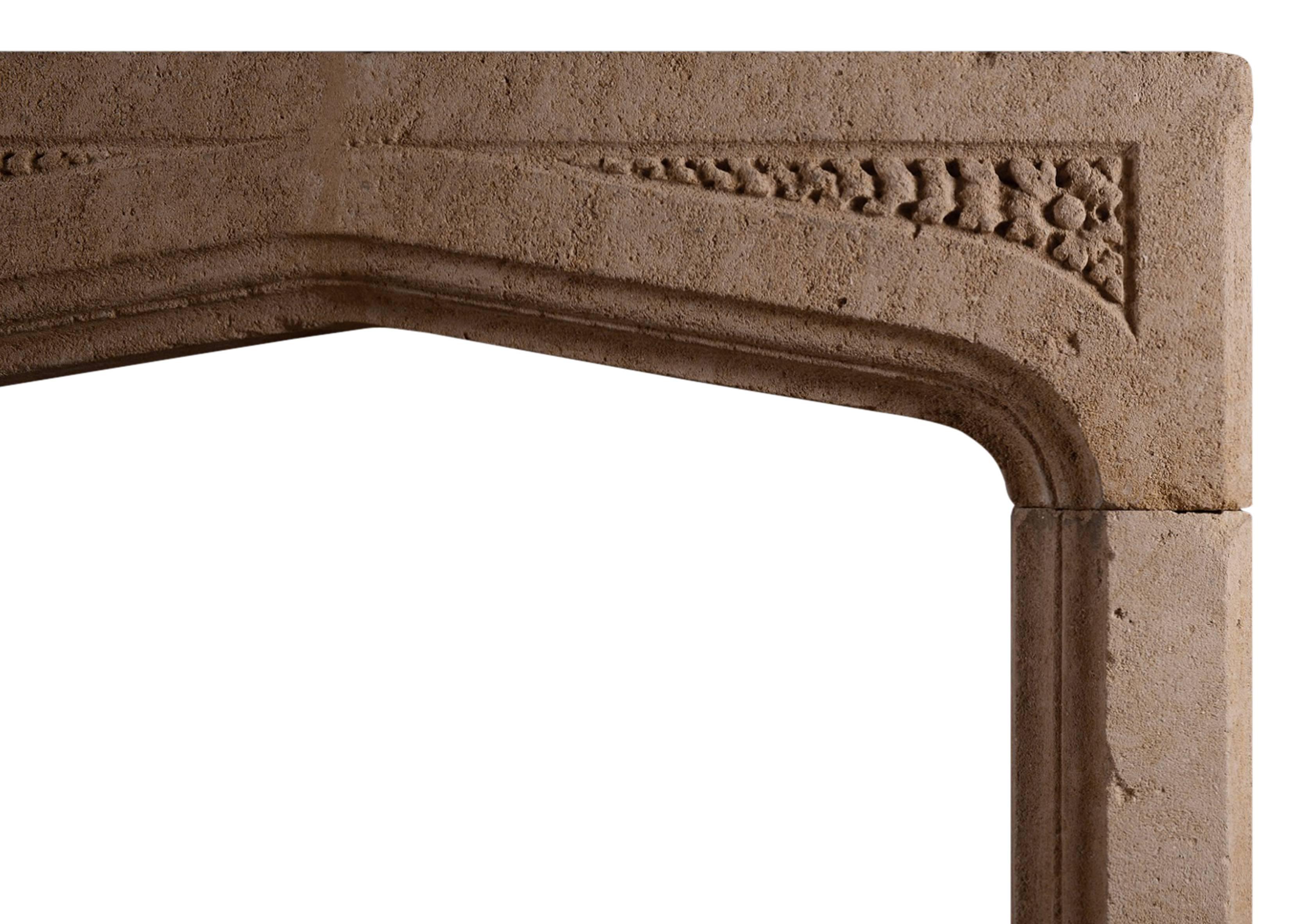 An English stone fireplace in the Gothic manner. The frieze with spandrels carved with foliage, 19th century.

N.B. May be subject to an extended lead time.

Measurements:
Shelf Width: 1400 mm / 55 1/8 in
Overall Height: 1135 mm / 44 5/8 in
Opening