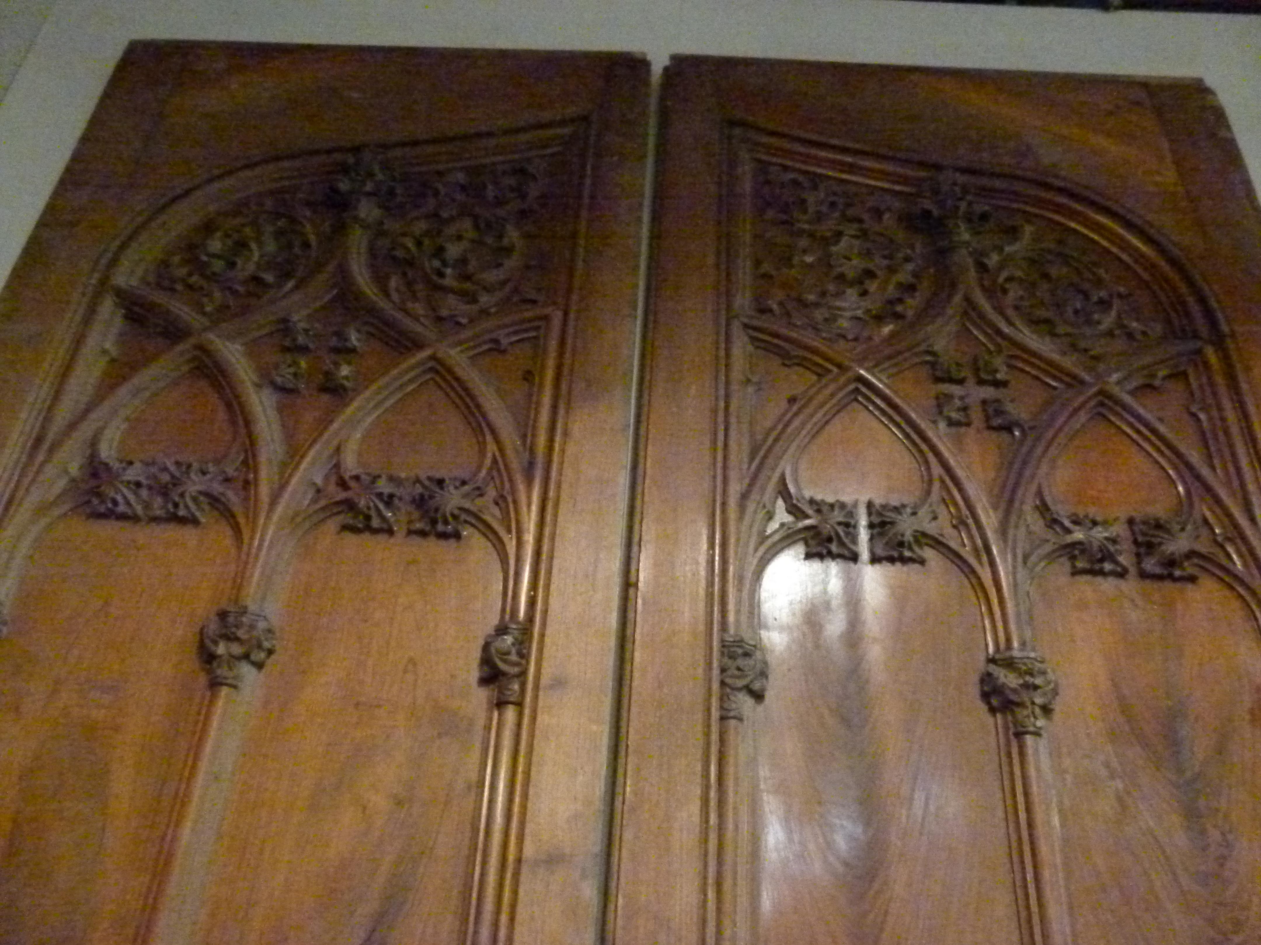 Gothic Revival Style Antique Wooden Double Leaf Door from Spain. Hand carved decorations in gothic revival style with Iron door handles in Seahorse shape.
The left leaf door has a minor loss as you will appreciate in one of the photos that we will