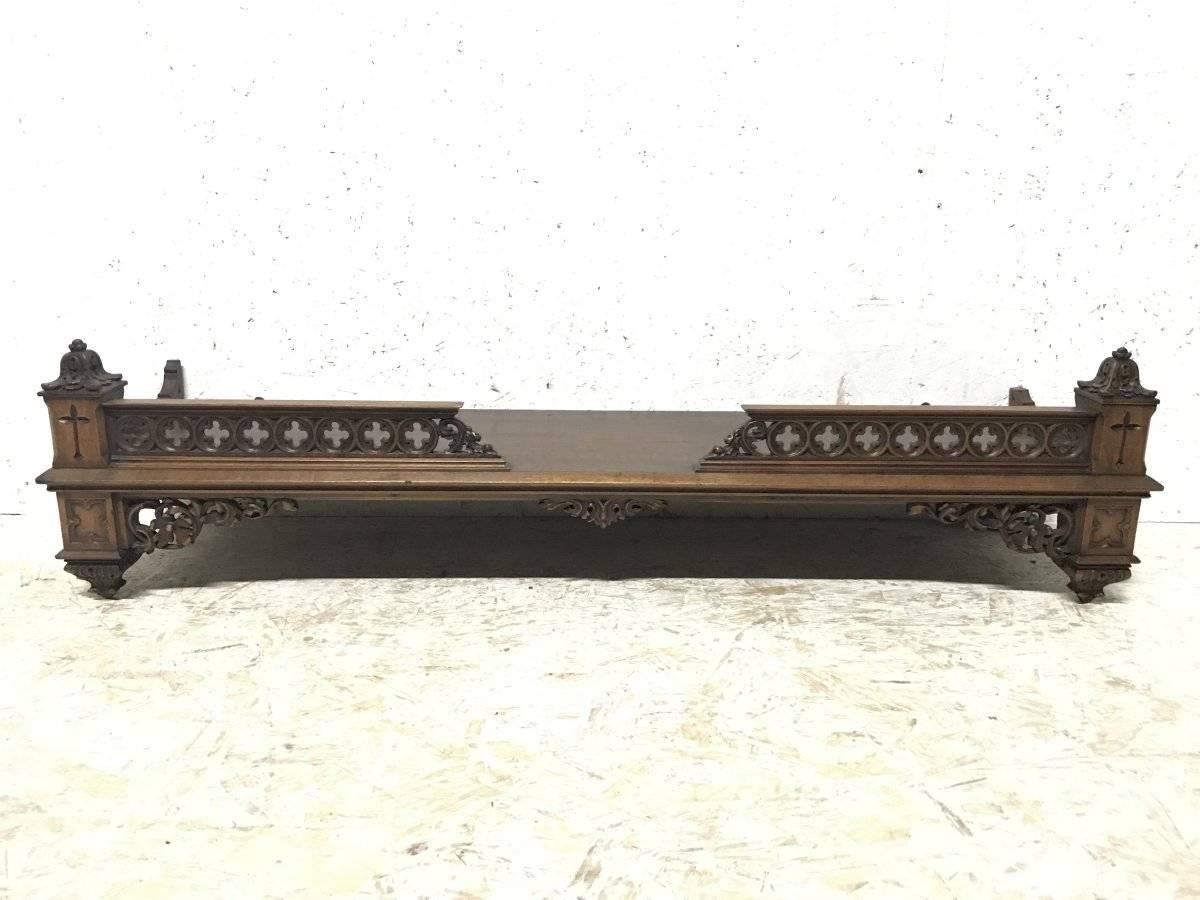 An unusual Gothic Revival walnut wall shelf with pierced qua-trefoils to the left and right upper galleries, flanked by carved floral flowing details below.
With brass wall mounting fixing hooks.
Measures: Height at the front 12 inches, height at