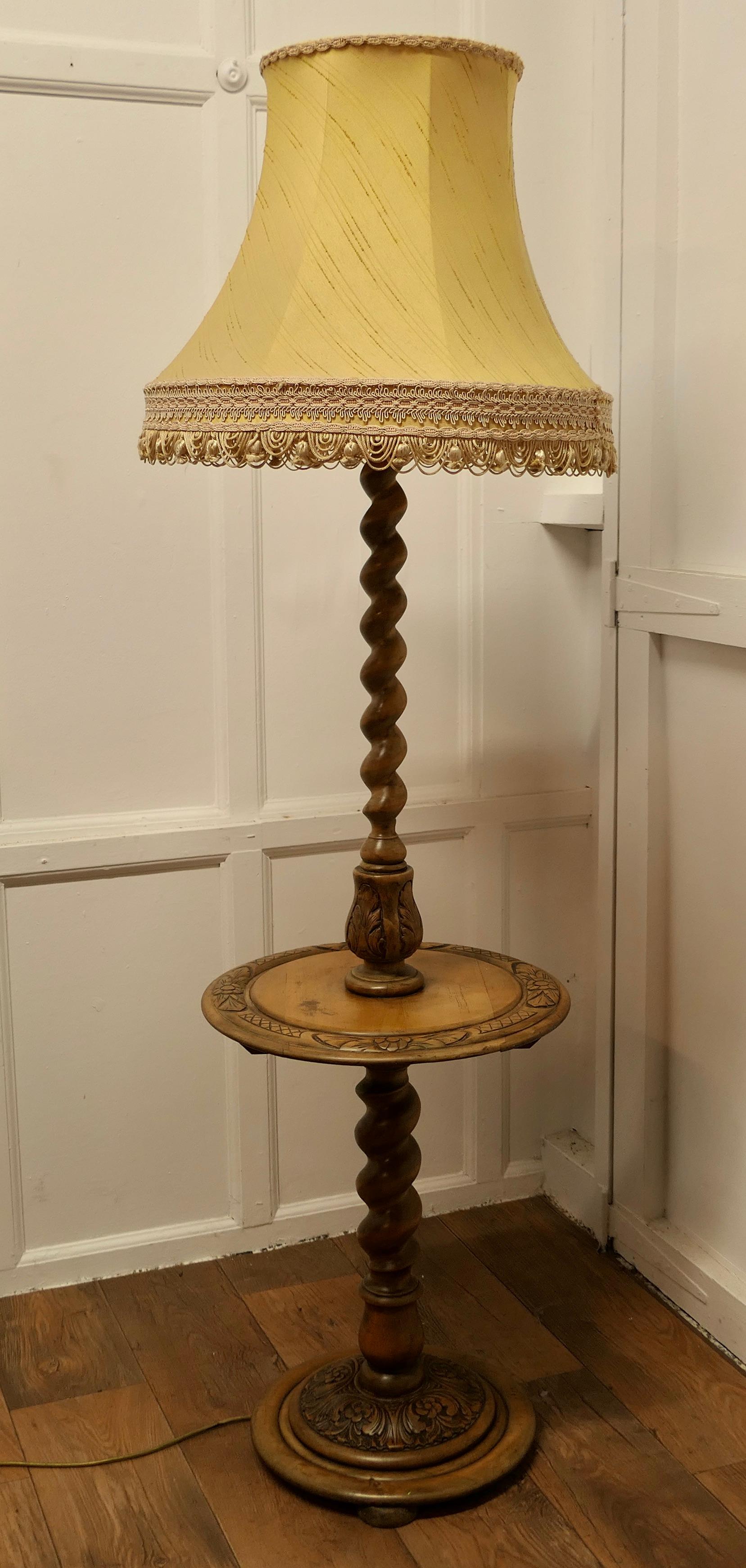 Gothic Style Barley Twist Floor Lamp Table

This is an unusual Piece, the base of the lamp is in the form of a small carved wine table and the lamp rises from the centre 
The wooden column of the lamp has delightful chunky barley twist turning
The