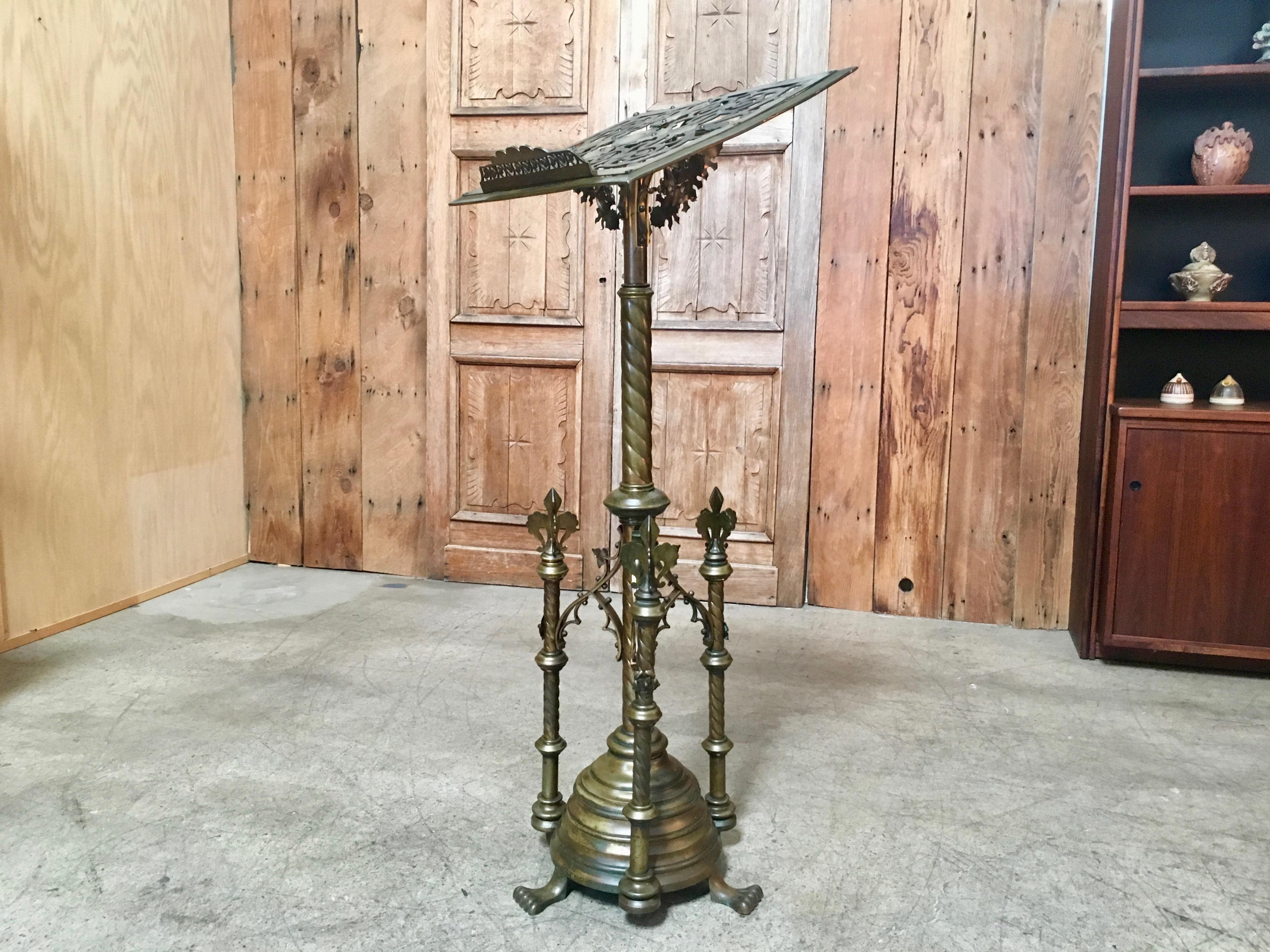 Intricate cast brass Bible stand or music stand in the Gothic style on solid brass wheels for easy moving.