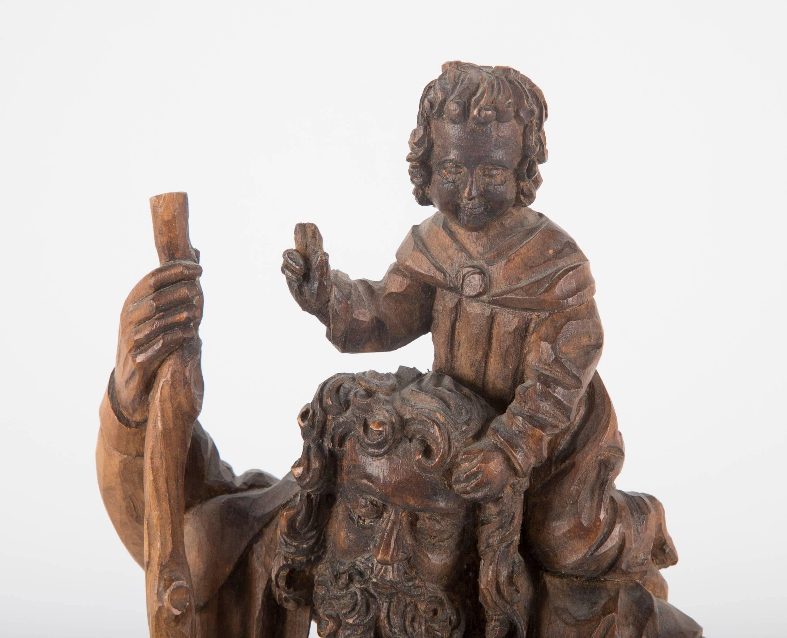 A 19th century German walnut carving of Saint Christopher carrying the Christ Child on his shoulders. Beautifully carved in the 15th century Gothic style. Labeled Oberammergau, a town in Bavaria known for its Passion Plays.