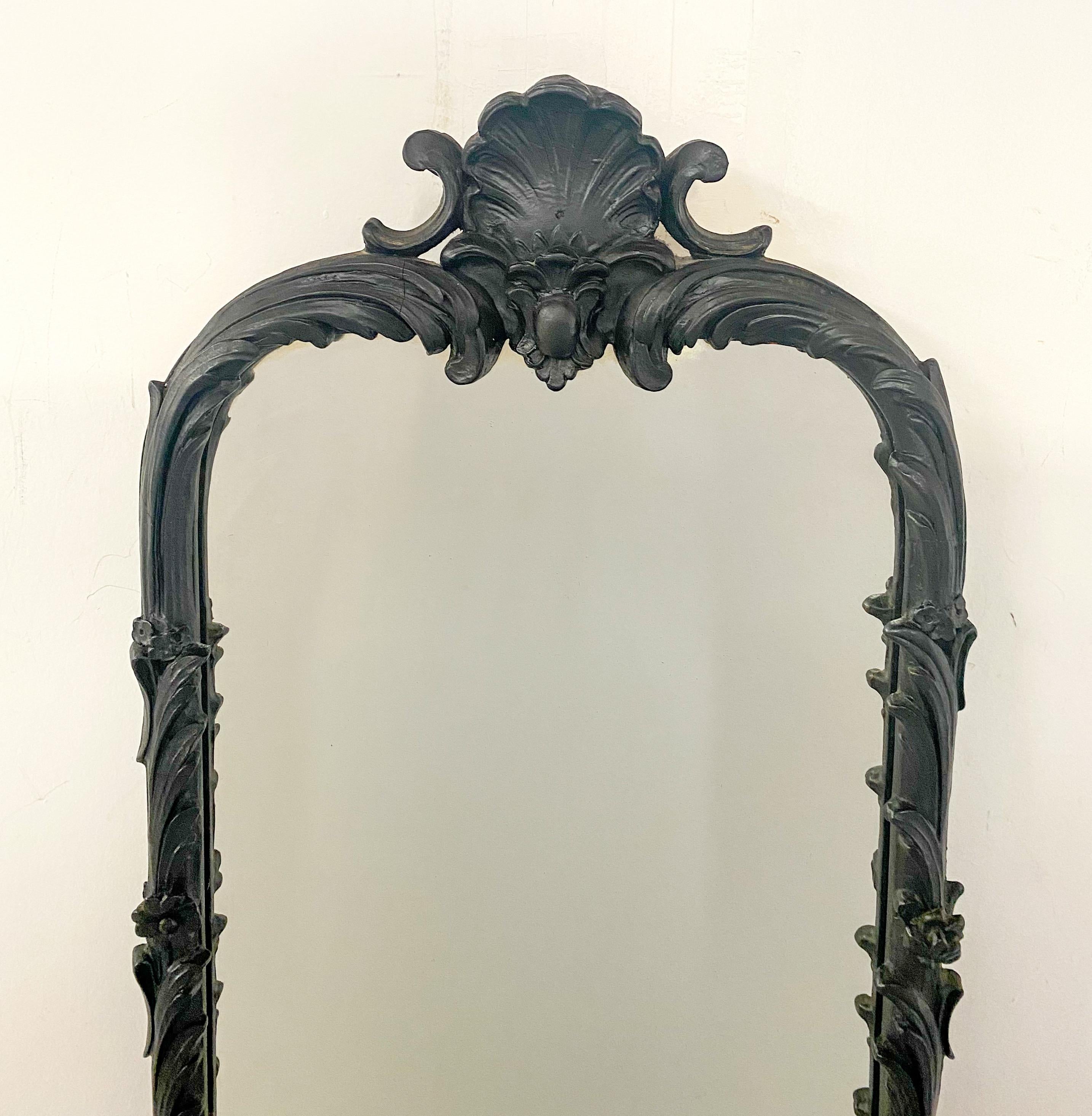 An elegant Gothic style wall tall mirror made of cast iron in black. The top of the mirror frame feature a large acanthus and scroll forms, the rest of the frame is embellished with exquisite flowers and long leaves design. The mirror is sturdy and
