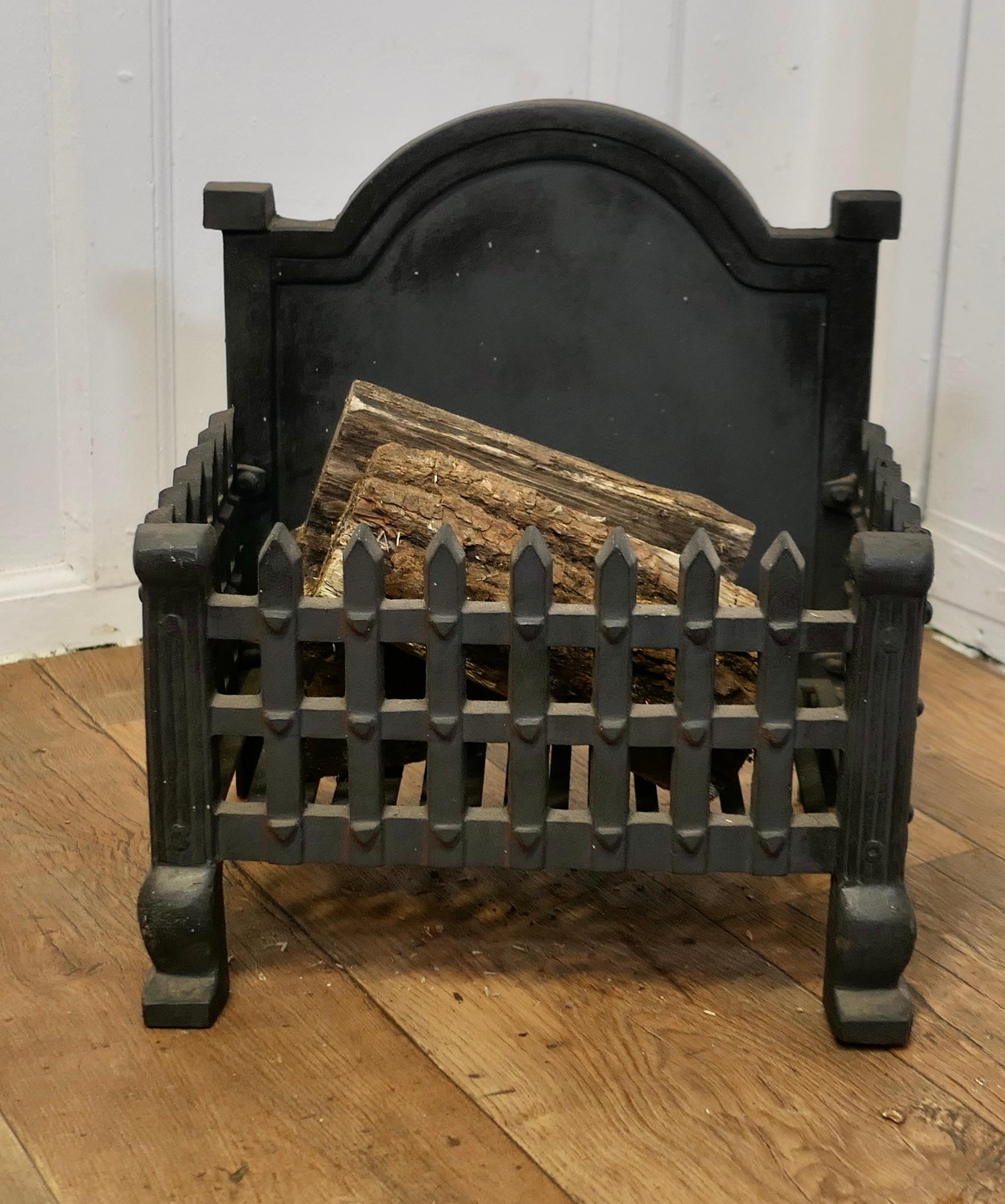 Gothic Style Free Standing Fire Basket, Grate

This is a useful and decorative piece, it has an arched fire back and the body is made of portcullis pattern sides and front
Although the grate has seen a little bit of use is still in excellent