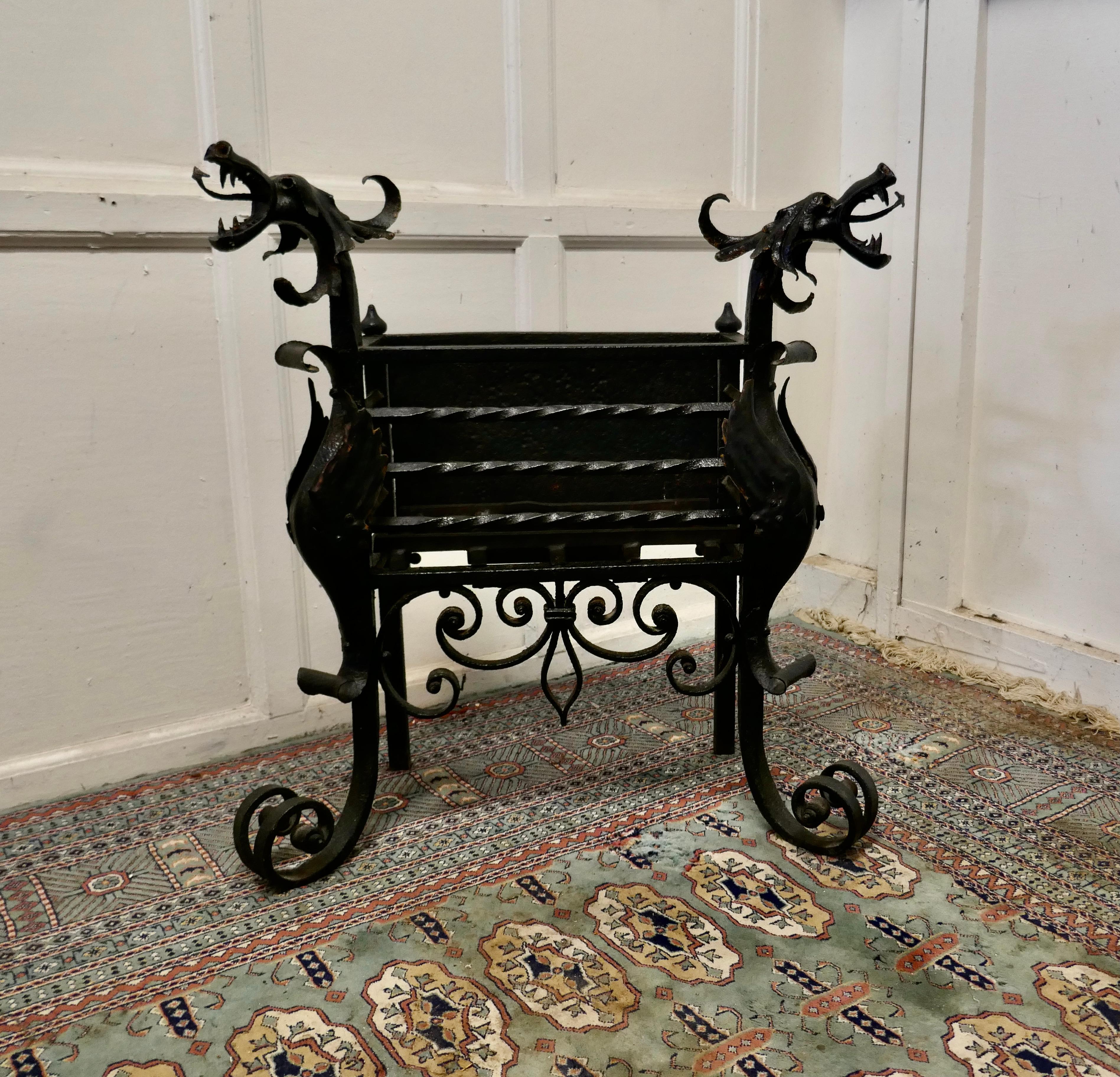 Gothic style free standing tall fire basket, Grate for Inglenook 

This is a Quirky and decorative piece, it is blacksmith made with 2 large Ornamental Dragon’s Heads at each side, these are supported on large scrolling feet
The grate has a solid
