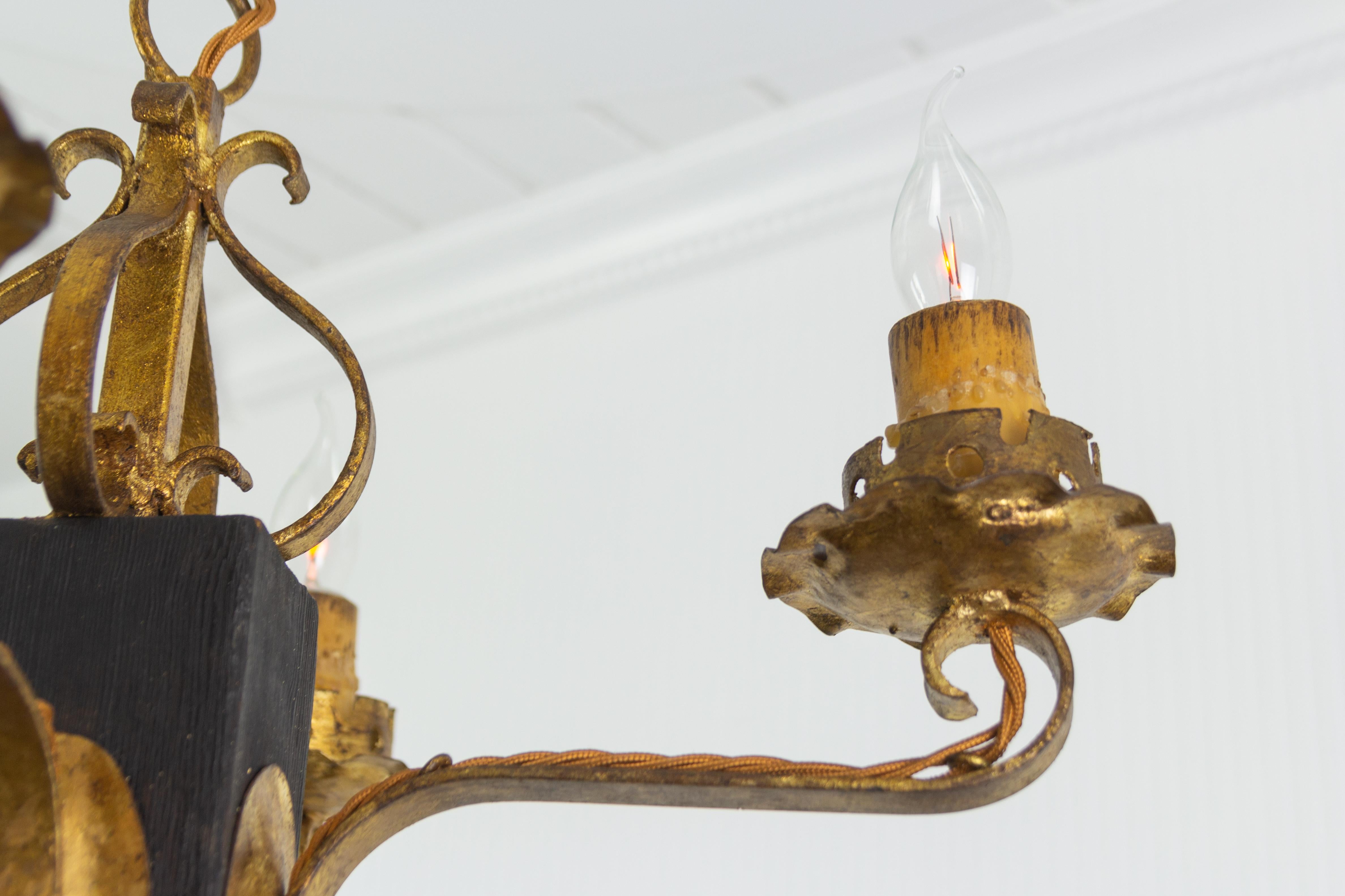 Mid-20th Century Gothic Style Gilt Wrought Iron and Black Wood Four-Light Chandelier For Sale