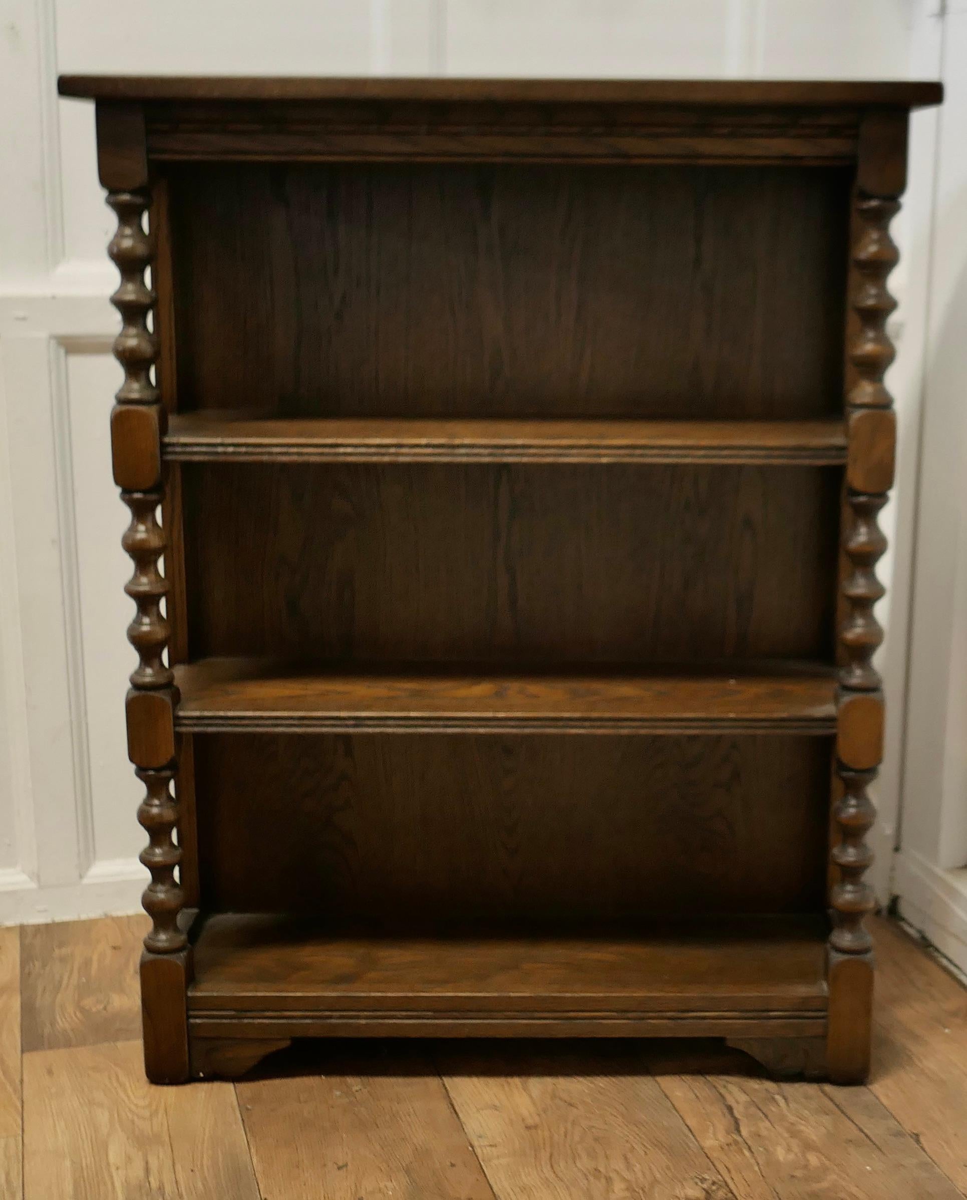 Gothic Style Oak Open Bookcase by Old Charm

A Charming little piece dating from about 1920, the bookcase has attractive bobbin turned columns at each side supporting the shelves
TheBookcase is made by Old Charm, a company know for their quality
All