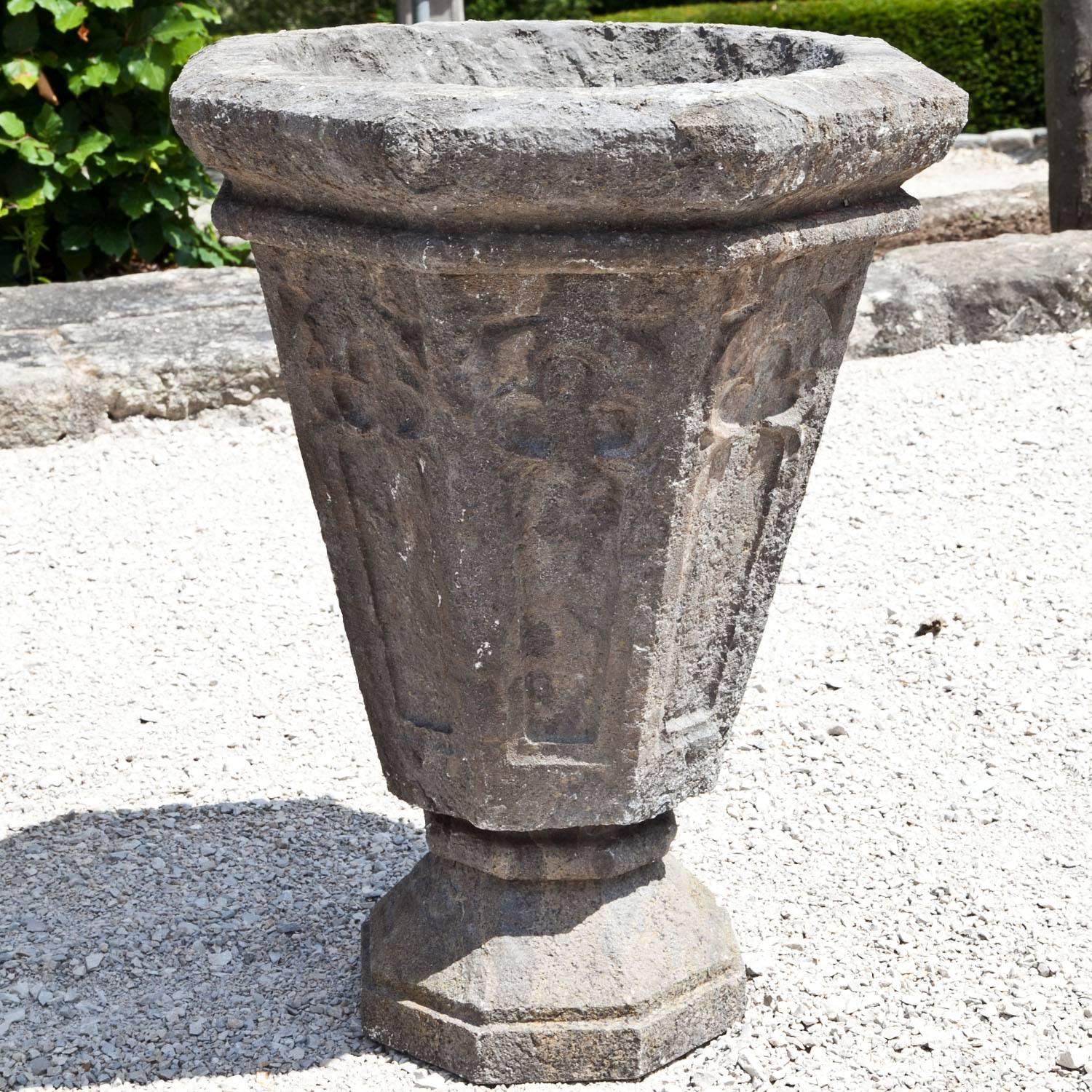 Pair of Gothic-style planters out of bluestone, with a hexagonal and slightly tapered body and trefoils on each section.