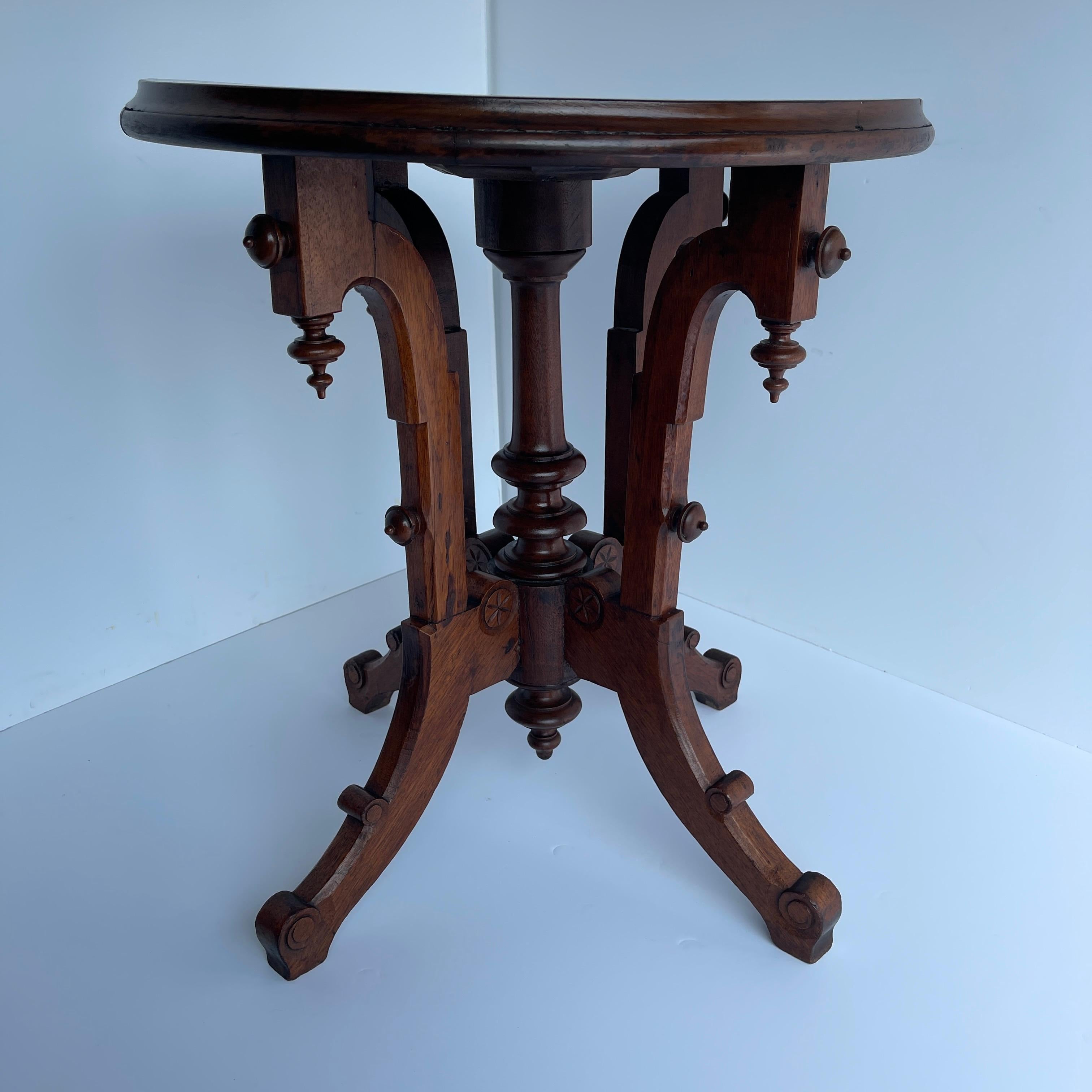 Late 19th century Gothic style round occasional side table.
Beautiful rich wood with ornately carved decorated sides, the curved legs hold this table in many settings or rooms of your home. Tall and perfectly suited beside a sofa as well as next to