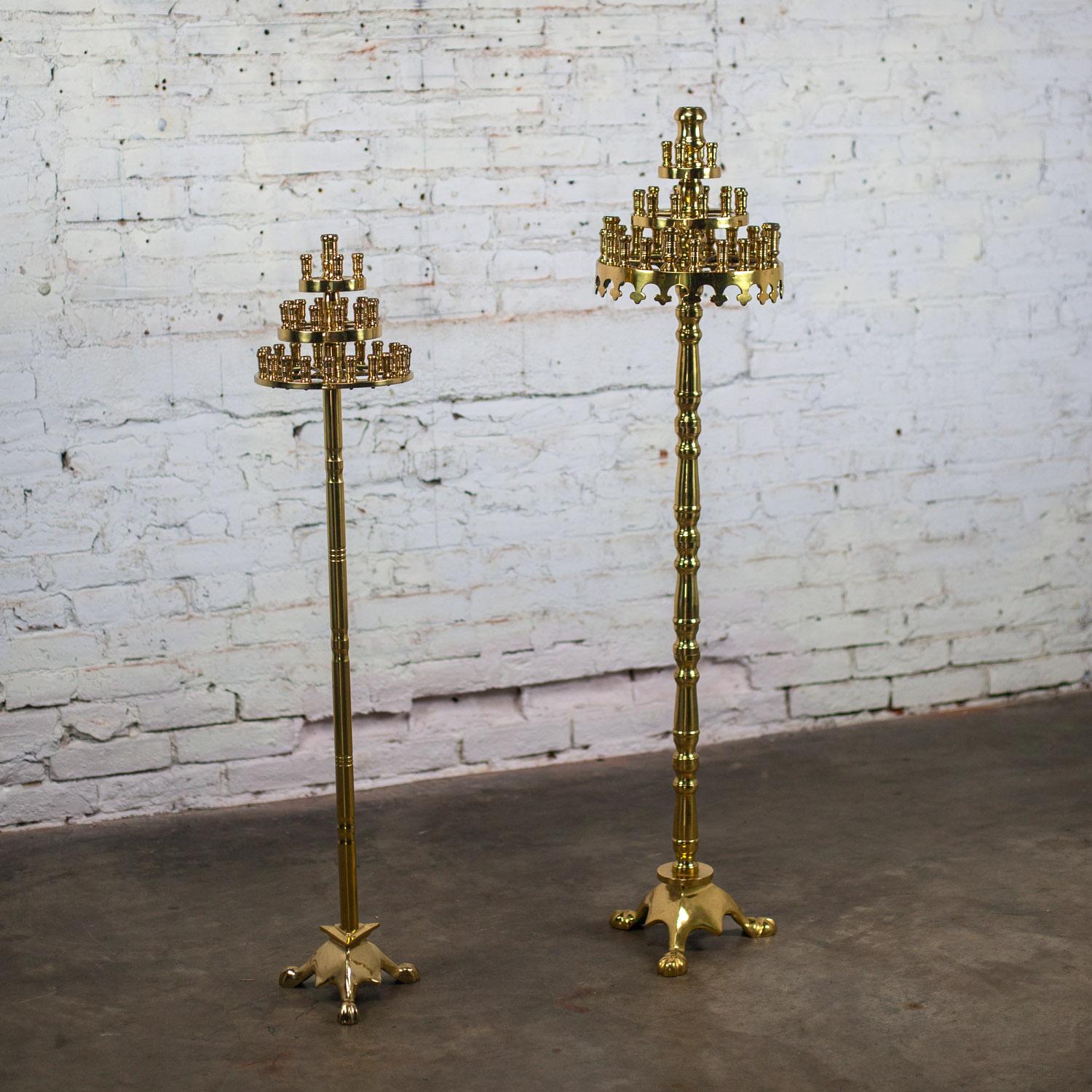Fabulous vintage Gothic style solid cast brass tiered floor standing candelabra with tripod bases, a pair. Beautiful condition, keeping in mind that these are vintage and not new so will have signs of use and wear even if they have been refinished