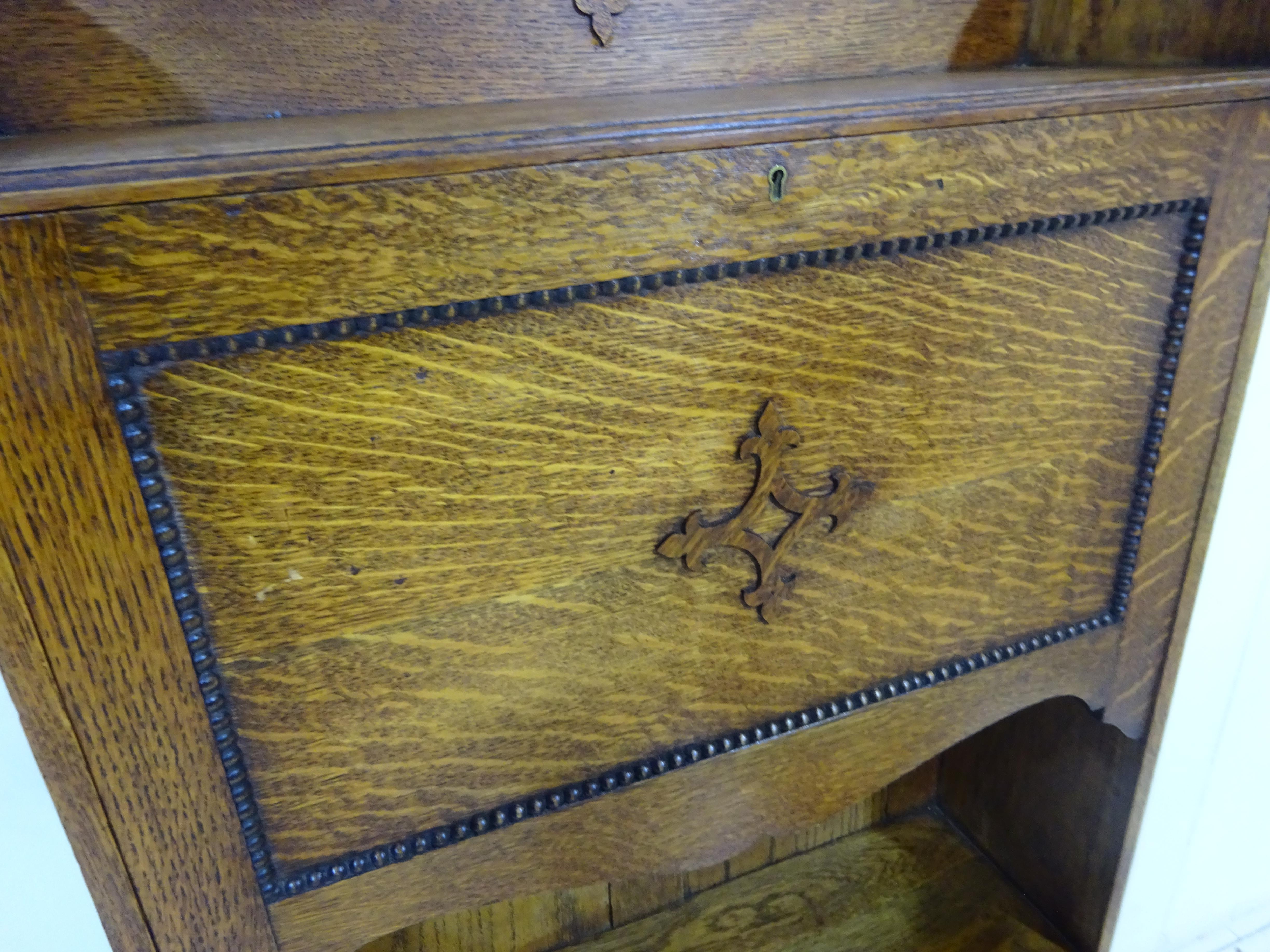 Writing desk

A special find by the team at The Eclectic Trading Company.

A lovely space saving, antique writing desk for those wishing to work from home!

This is a late Victorian writing desk in a Gothic style. Handcrafted in solid oak the