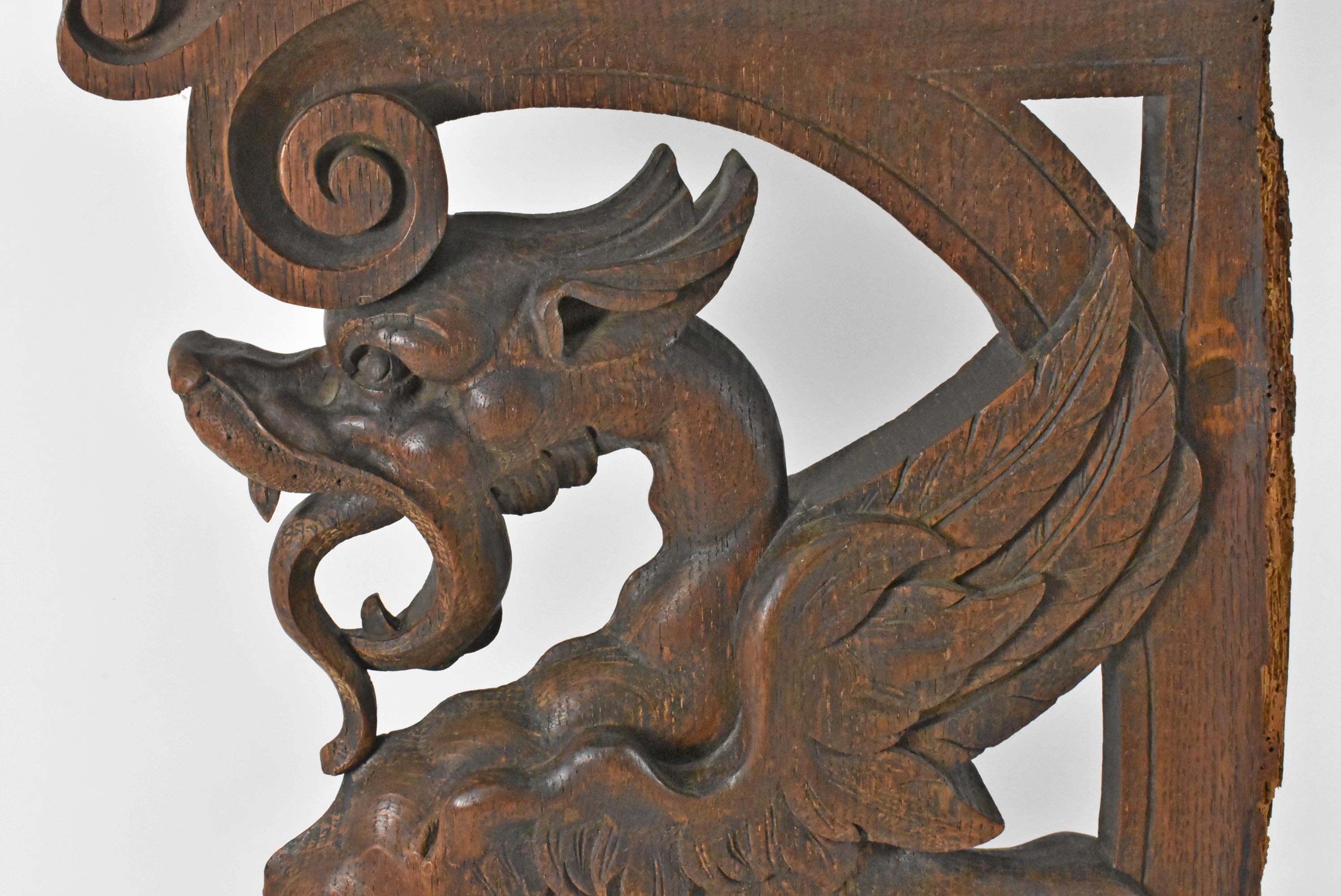 Gothic Winged Griffin architectural fragment in oak. Carved wing griffin in Quarter Sawn Oak. A likely fragment from a piece of furniture. Fair condition, shows some structural issues as shown in photos. Dimensions: 17.5