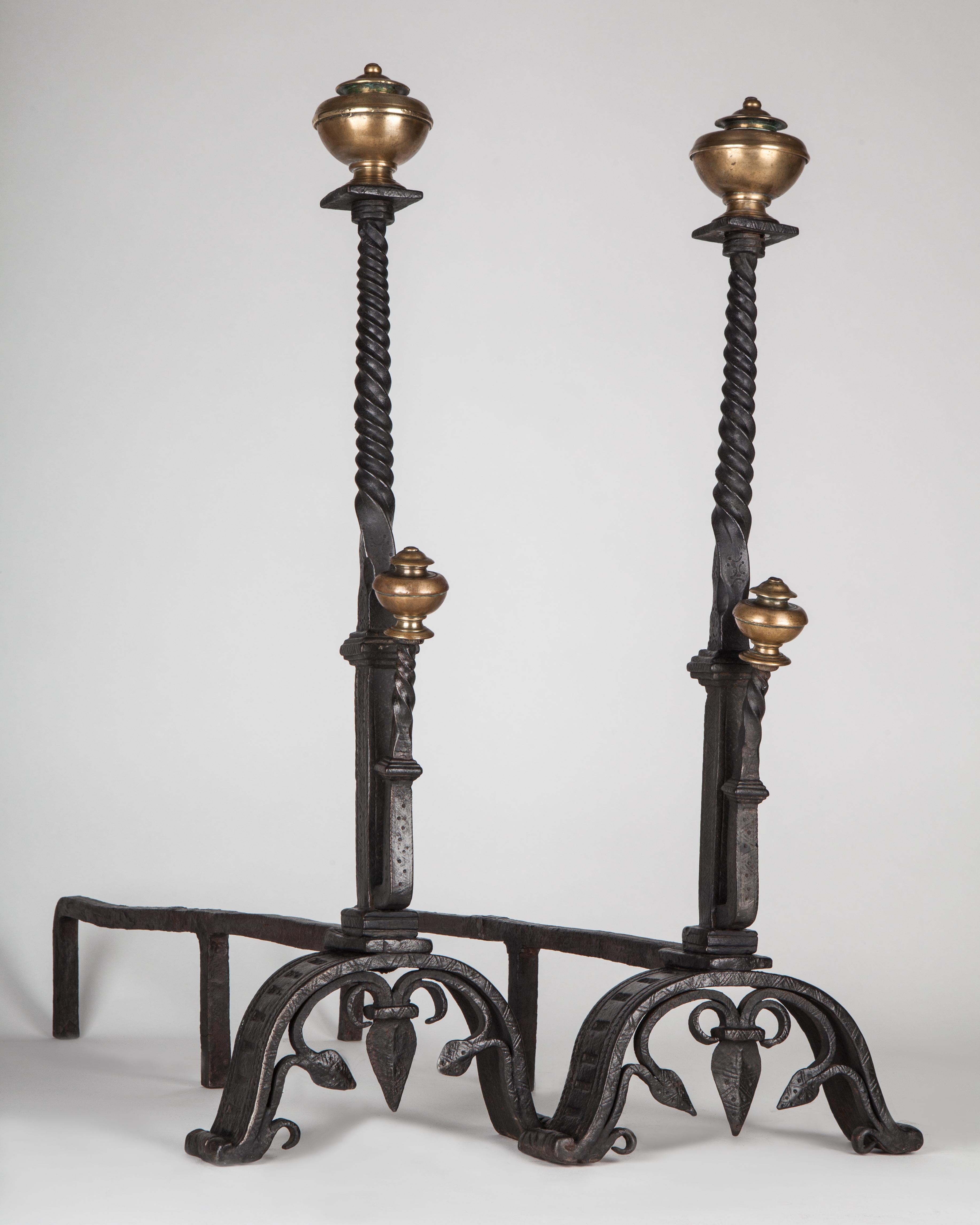 AFP0603
A pair of antique wrought iron andirons with twisted shafts and scrolled feet, terminating in turned aged brass finials. Circa 1920.

Dimensions:
Overall: 30-1/2