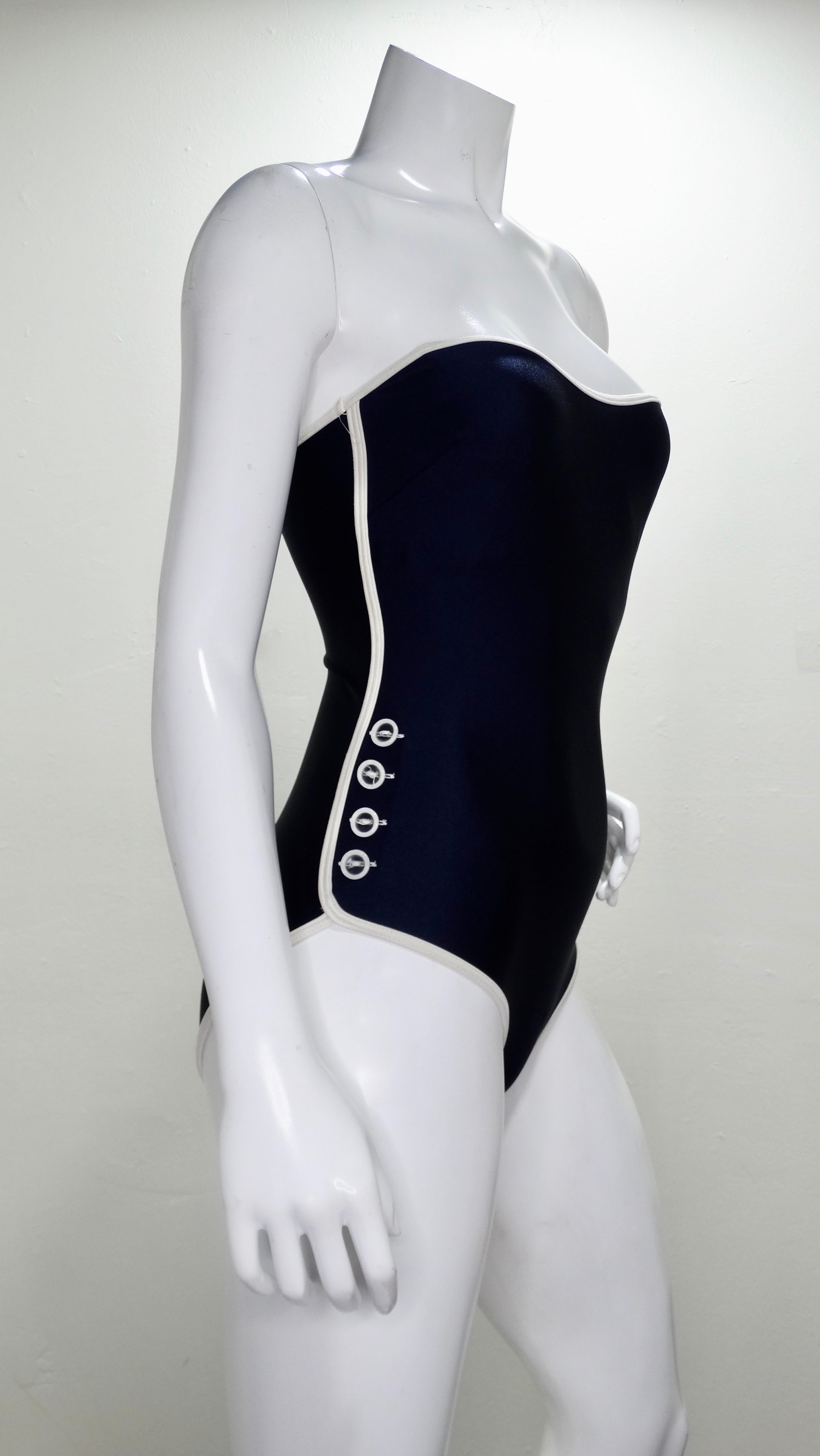 Be beach ready at all times with this adorable Gottex one piece swimsuit! Circa 1990s with a little 1950s influence, this strapless navy blue swimsuit features a white trim with buttons going down the hip. Interior includes a built in bustier.