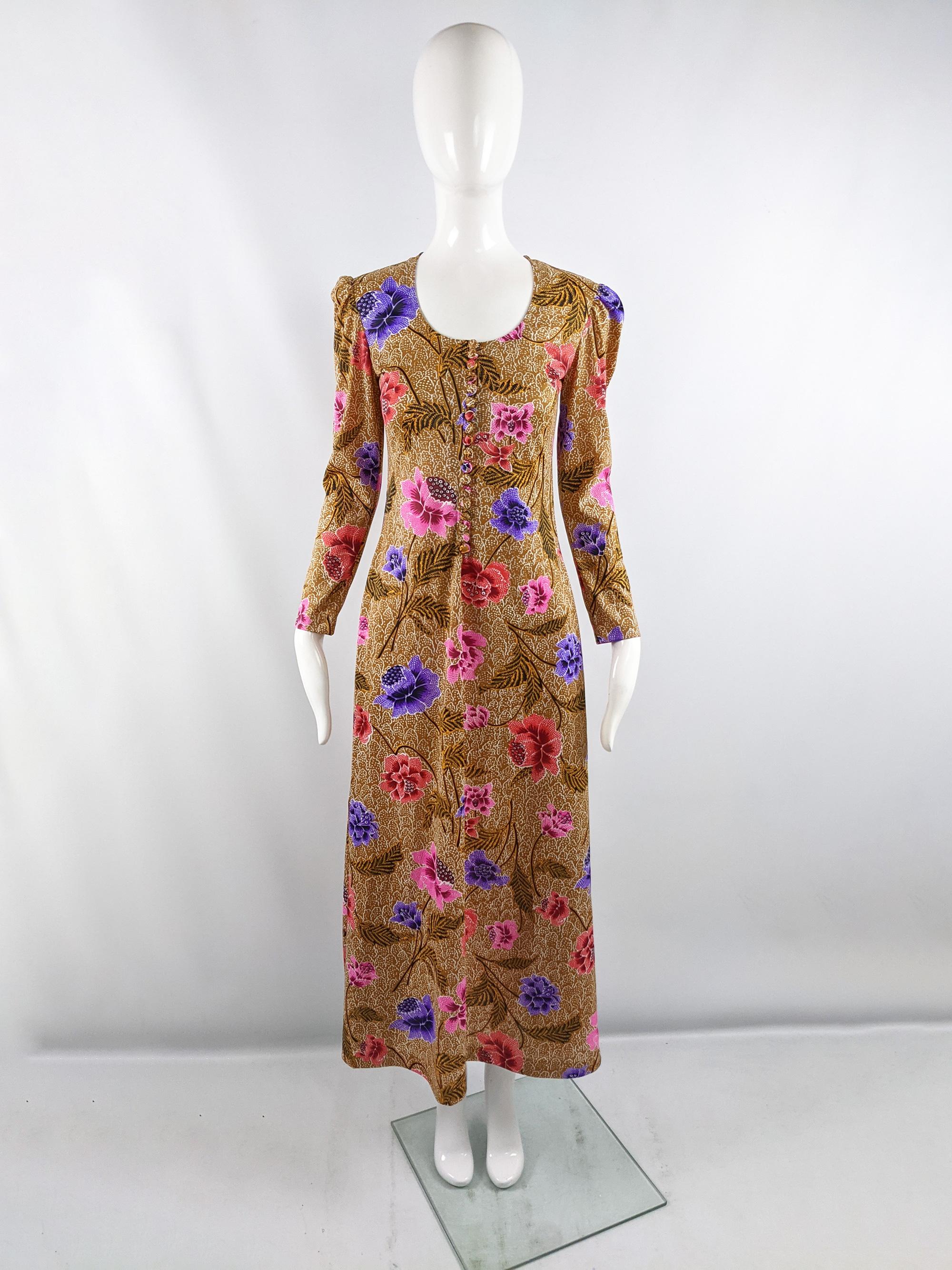 A fabulous vintage womens maxi dress from the 70s by luxury Israeli label, Gottex. Known for their luxurious beach cover ups and poolside dresses, this lightweight, long sleeve floral print dress would be great for a summer vacation or festival.
