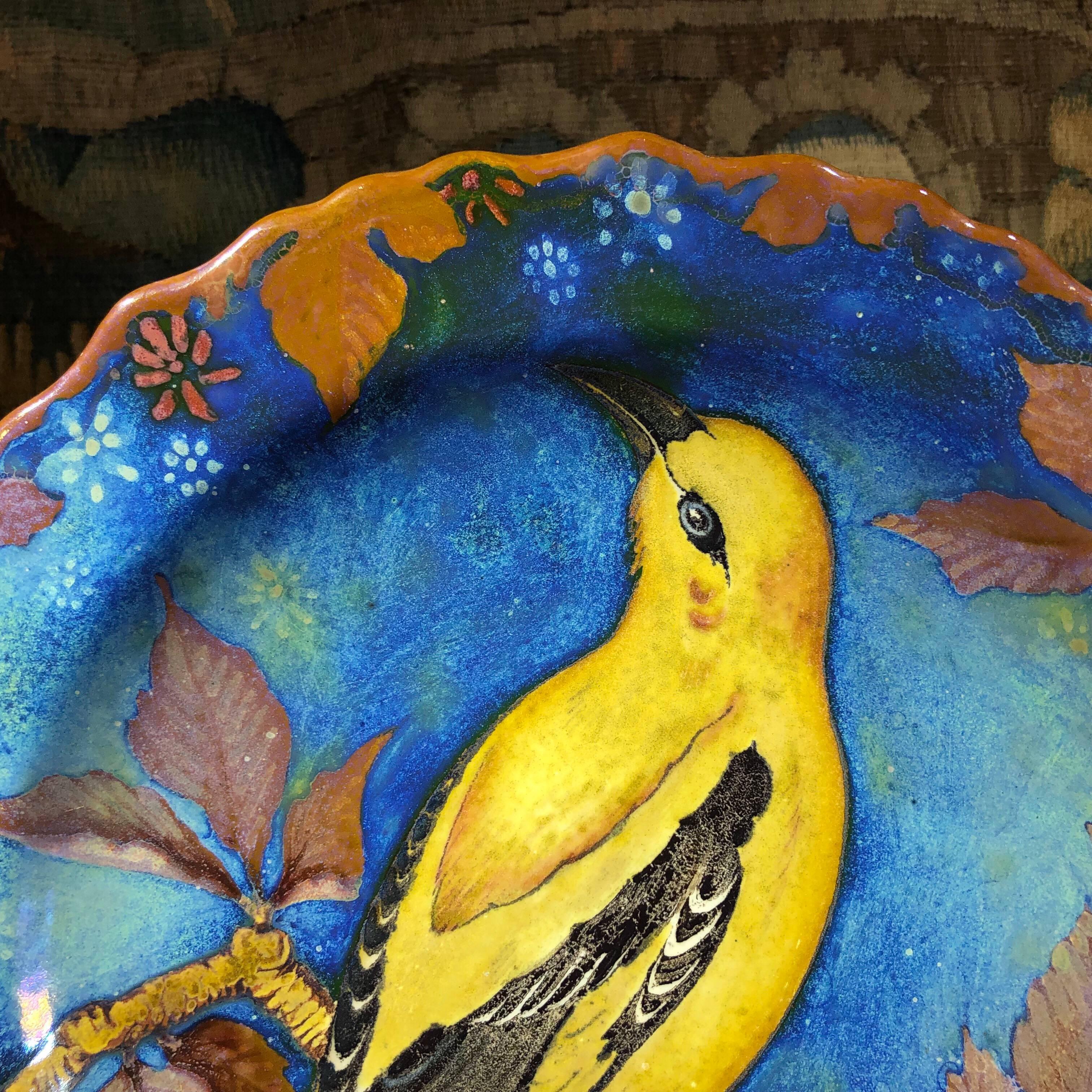 Gouda charger, the shallow lobed rim form with large slip painting of a yellow bird on branches. Extensive marks including 'UNIQUE / PLAZUID' painters mark JvS for circa 1935

References: Johannes van Schaick was a designer with Gouda 1920-51, and