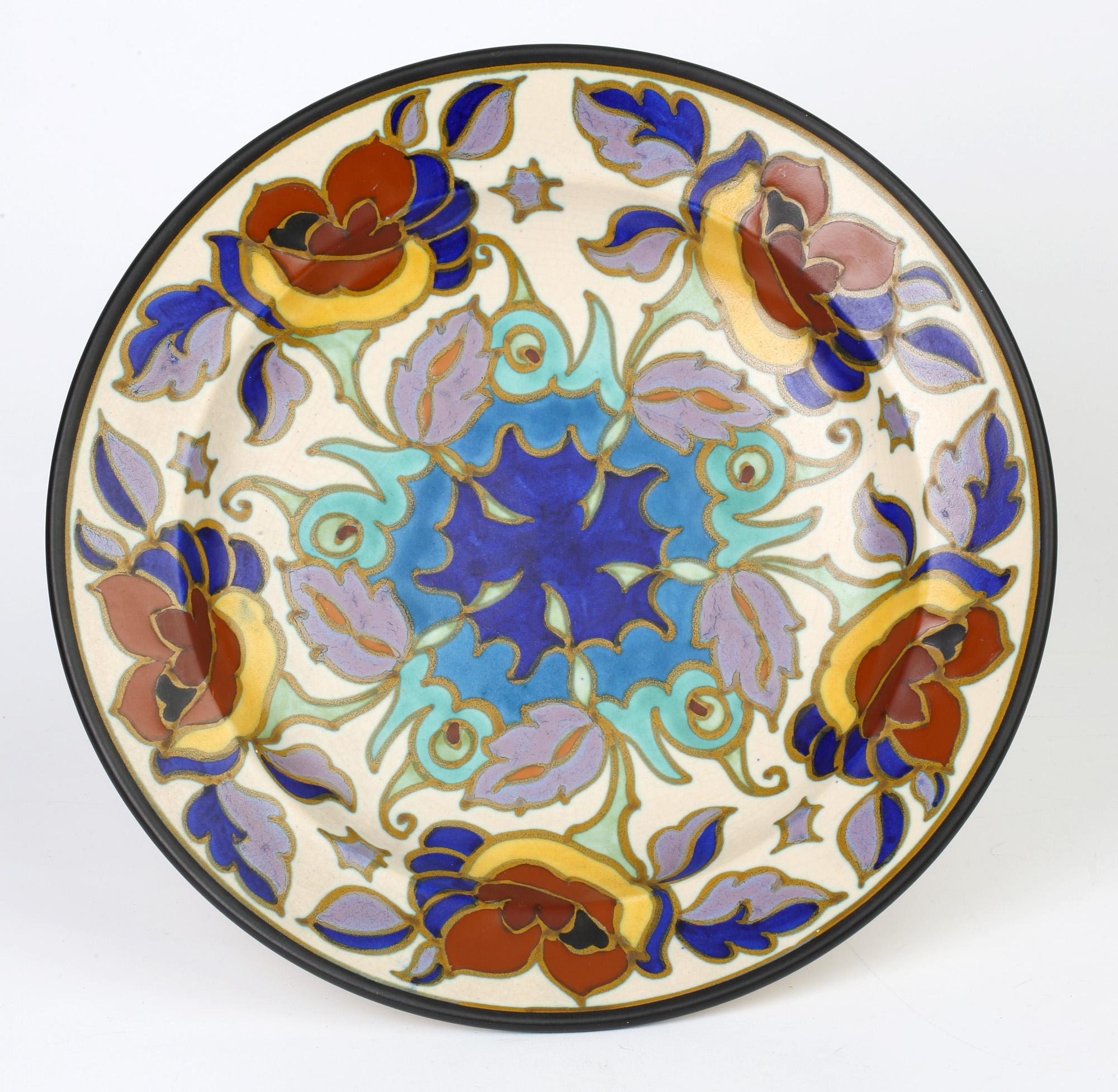 A stunning Dutch Gouda, Plateelbakkerij Zuid-Holland Art Deco pottery wall plate hand painted in the Art Nouveau inspired Gaberone design and believed to date between 1920 and 1929. The rounded bowl shaped plaque is body painted with a central