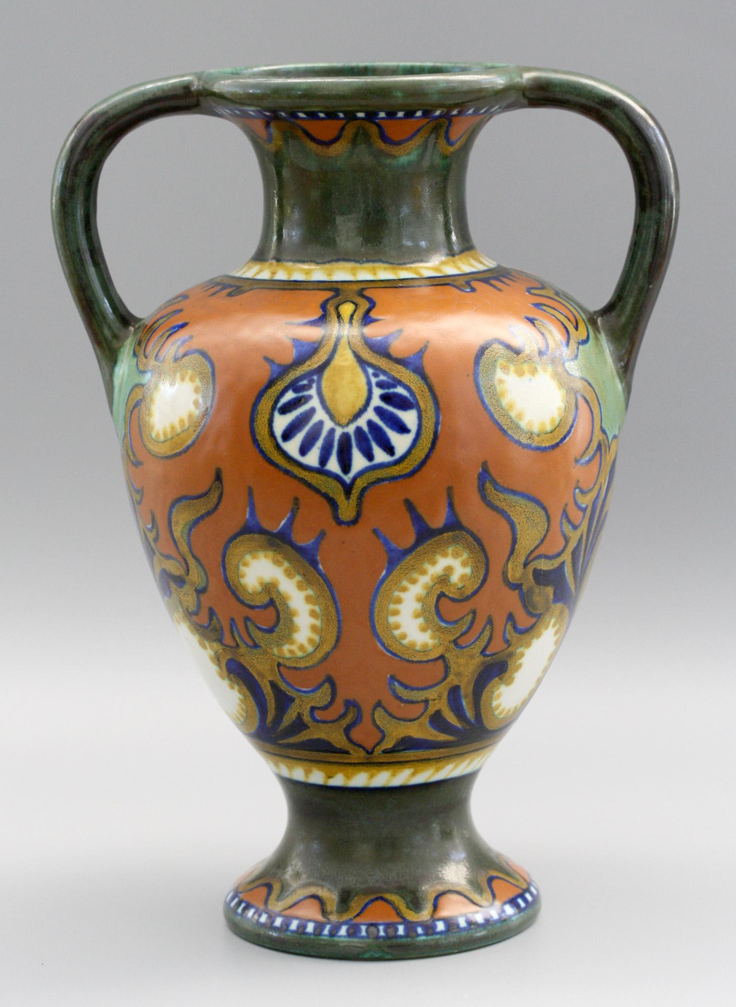 A very stylish Dutch Gouda Art Deco amphora shaped twin handled art pottery vase decorated in the Rhodian pattern and made at the Plateelbakkerij Zuid Holland and designed circa 1924. The vase stands on a rounded pedestal foot with a pear shaped