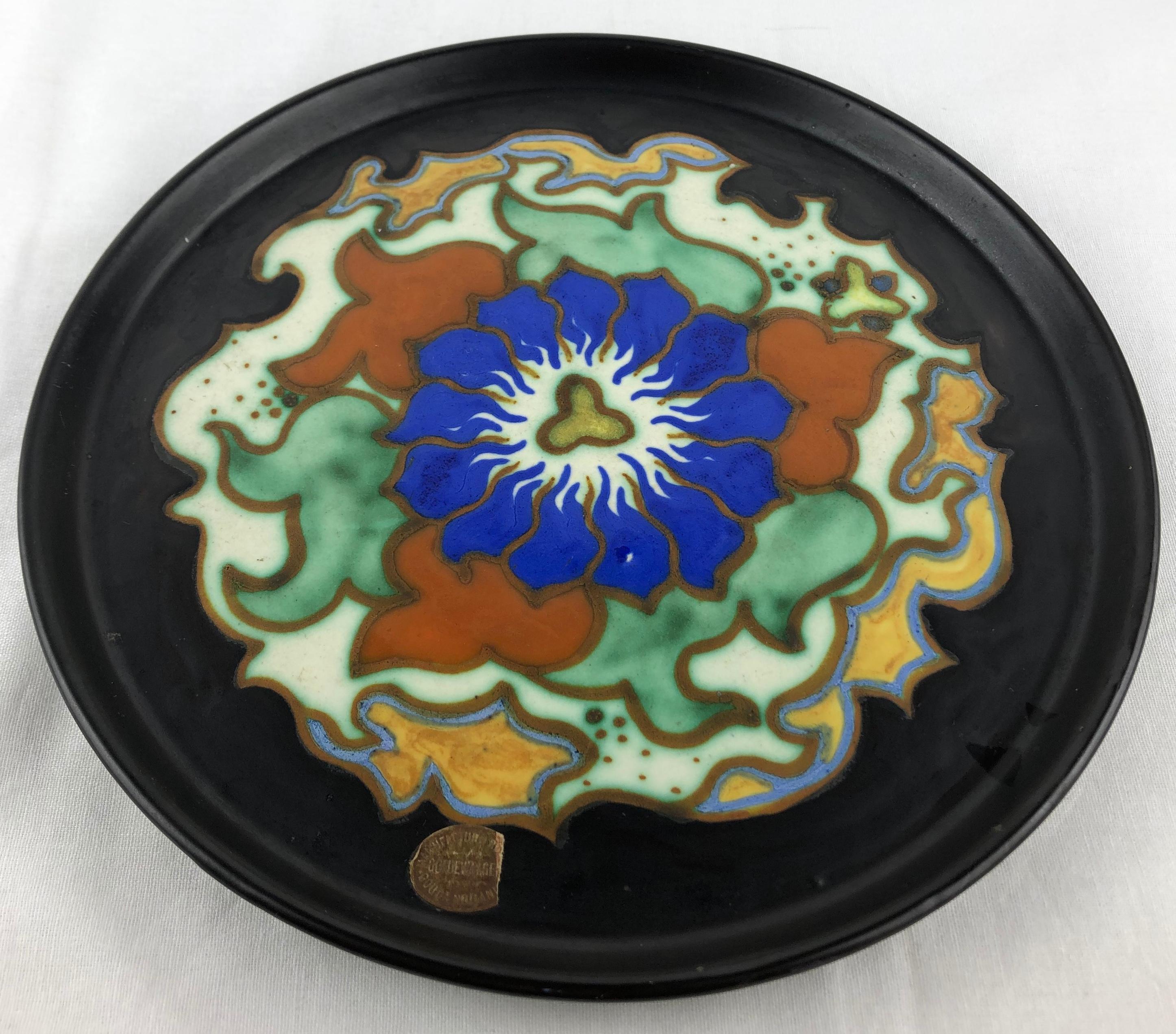 Dutch Art Nouveau ceramic dish from Gouda, Holland with traditional period flowery and curvaceous designs. Matte glaze, mixture of abstract and floral designs, circa 1920s.

Very colorful and pleasing to the eye.
Beautiful handcrafted, hand