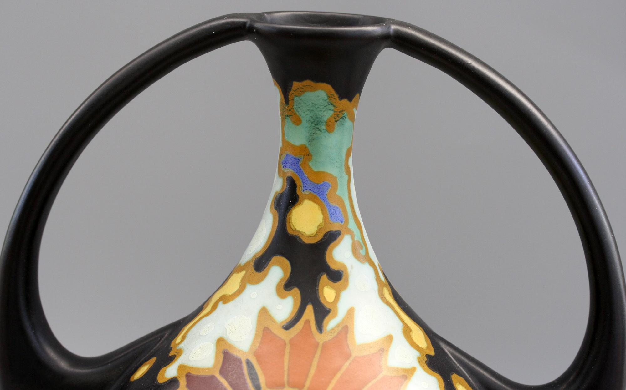 A very stylish Art Deco Dutch Regina Gouda twin handled art pottery vase decorated in the Presto pattern and designed by Steef Boers in 1927. This elegantly shaped vase has a bottle shaped body applied with prominent looped handles extending from
